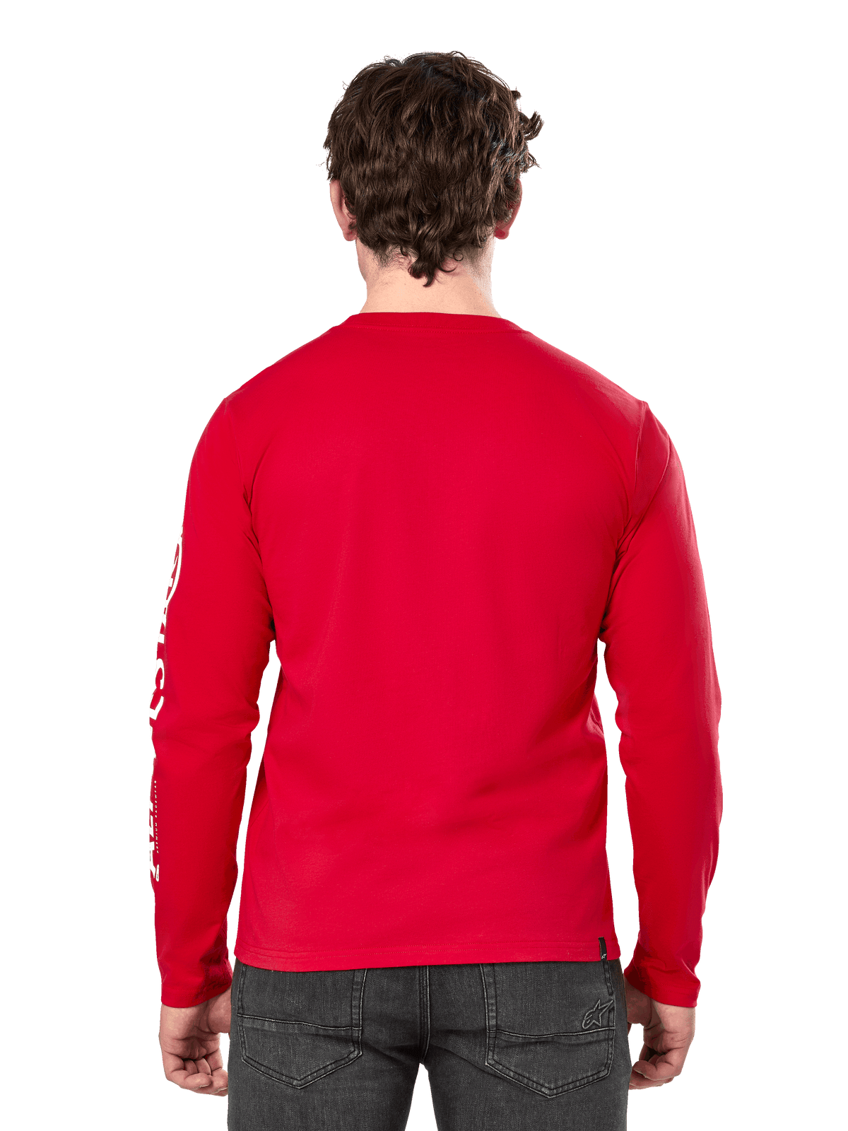 Rear view of a man wearing the Alpinestars Committed CSF Long Sleeve Tee in Red, paired with dark grey jeans, featuring a visible Alpinestars sleeve logo in white and a minimalist back design.