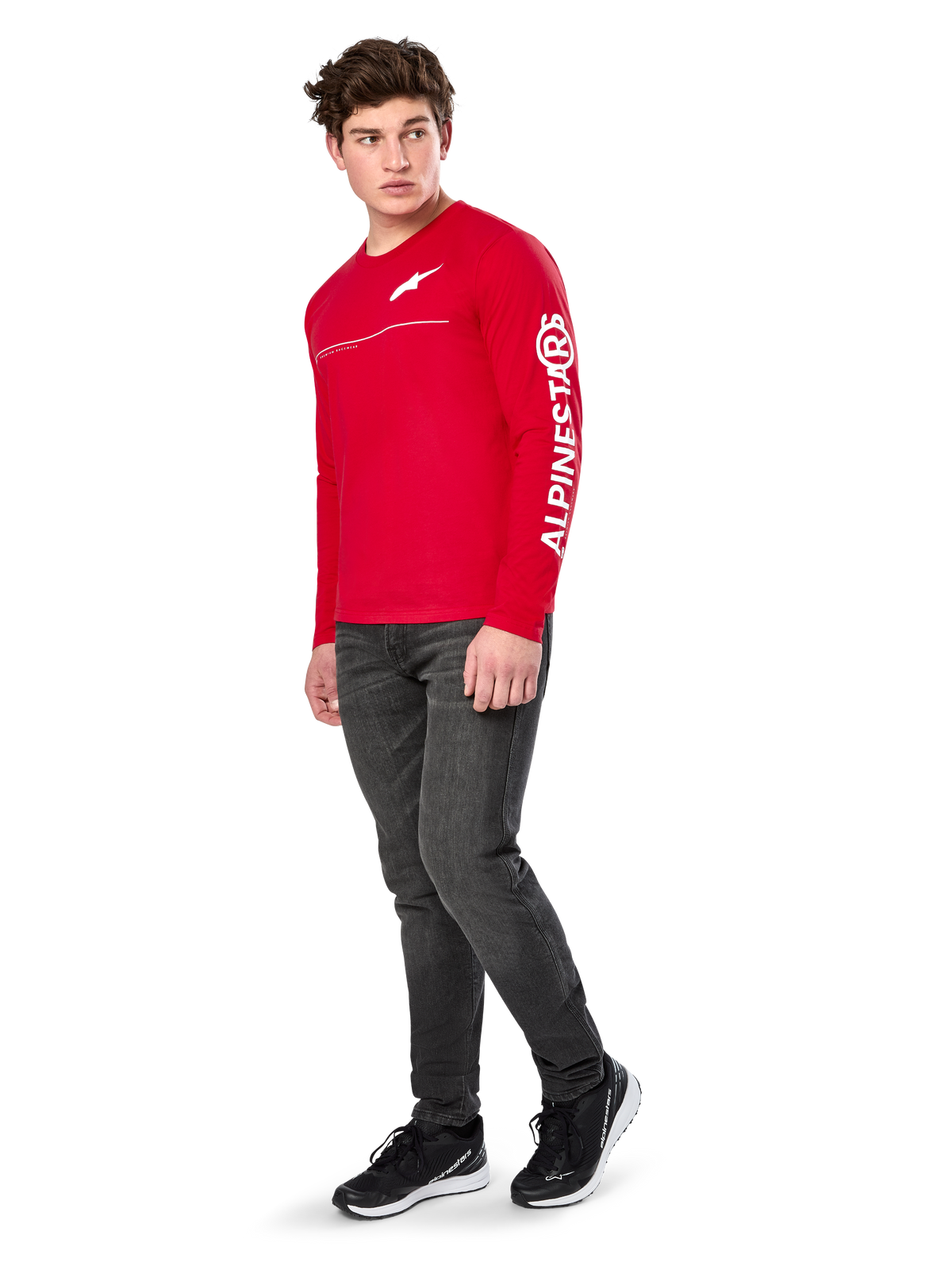 Alpinestars Committed CSF Tee, Long Sleeve T-Shirt, Red, featuring white Astars chest logo and Alpinestars sleeve branding, worn by a model with dark jeans and black sneakers, casual motorsport streetwear