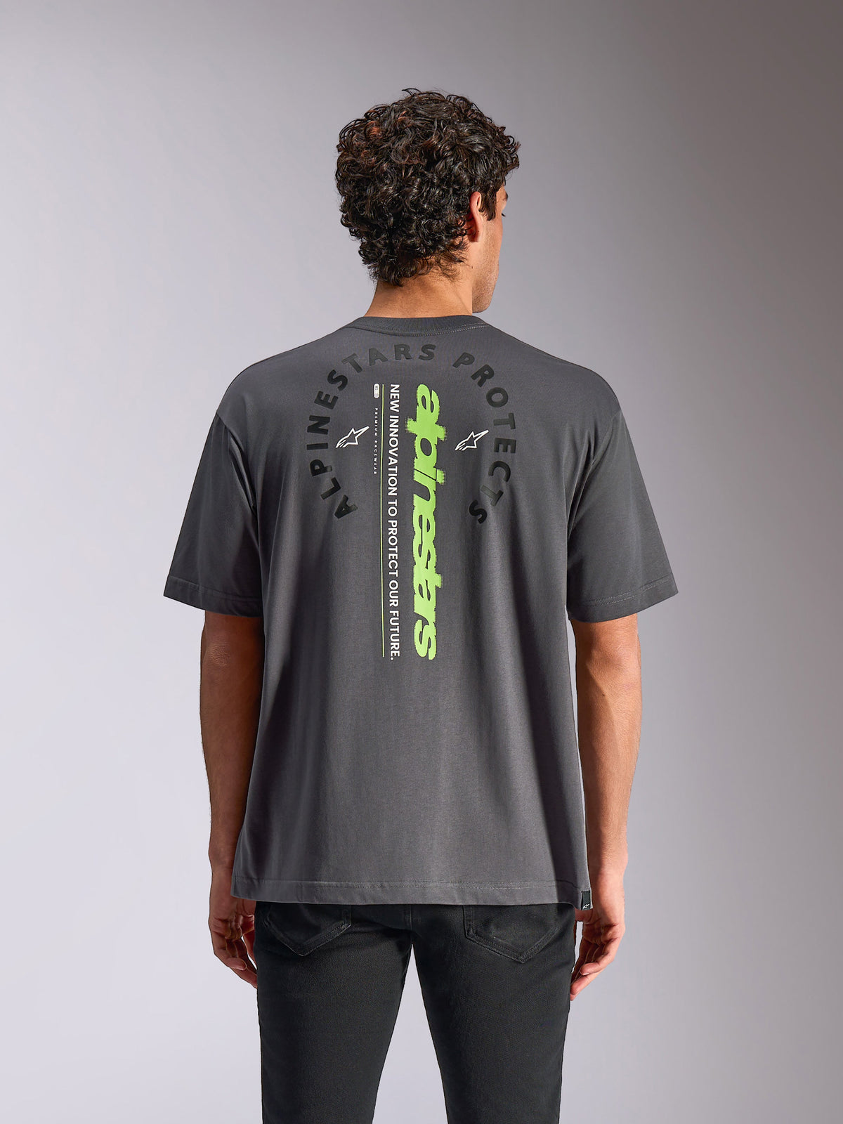 Alpinestars Overhang Oversized CSF Tee, Short Sleeve T-Shirt, Charcoal Gray, back view featuring vertical neon green wordmark and circular graphic, relaxed oversized fit, casual motorsport streetwear