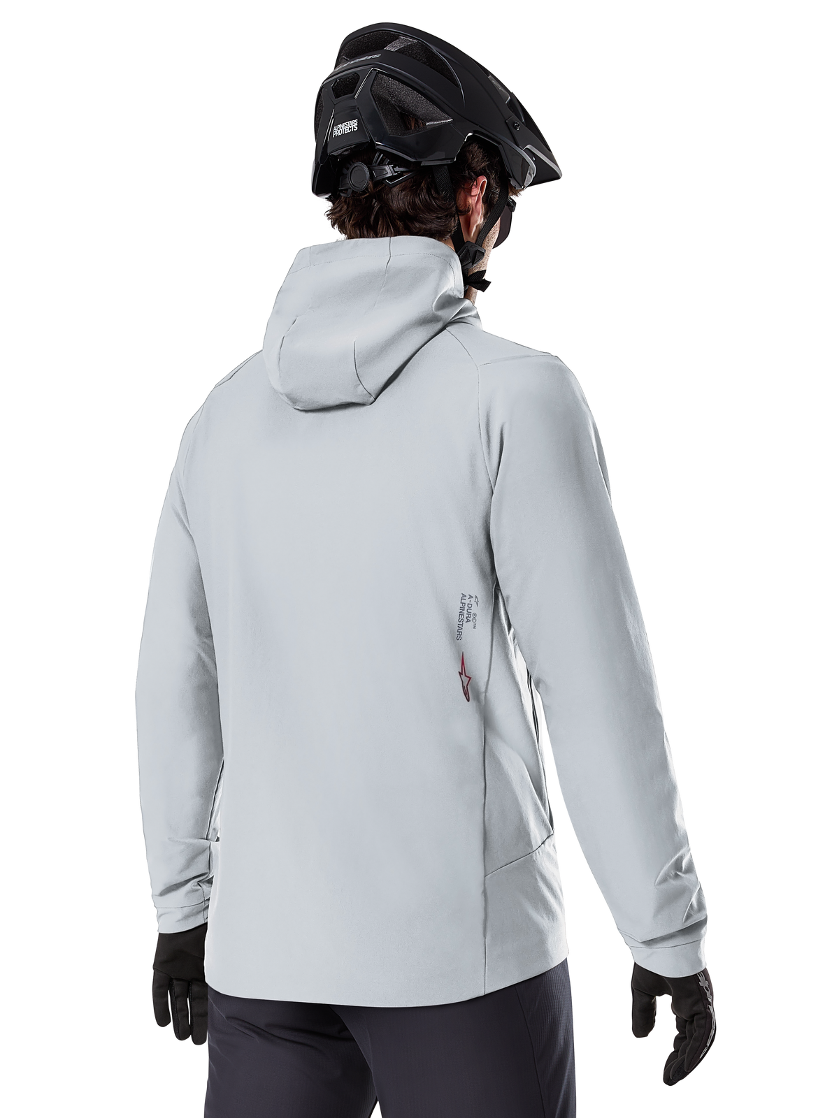 Alpinestars A-Dura Thermal Jacket, Titanium Gray, back view of a rider wearing the hooded insulated jacket, paired with a black MTB helmet and black gloves, featuring a small Alpinestars logo on the lower back, designed for cold-weather mountain biking.