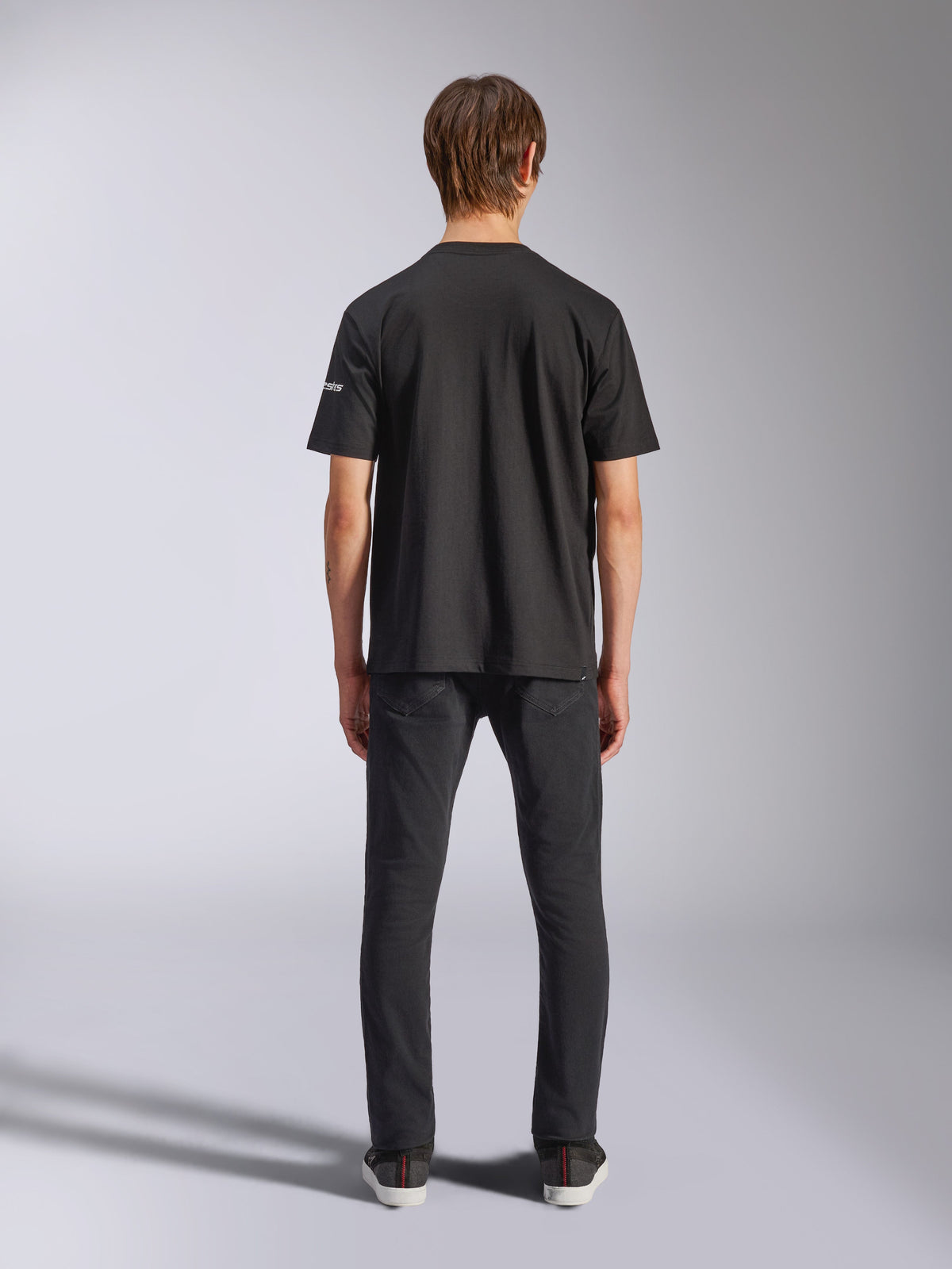 Alpinestars Frontal CSF Tee, Short Sleeve T-Shirt, Black, Rear view on model wearing black jeans, casual performance streetwear featuring small white sleeve logo detail