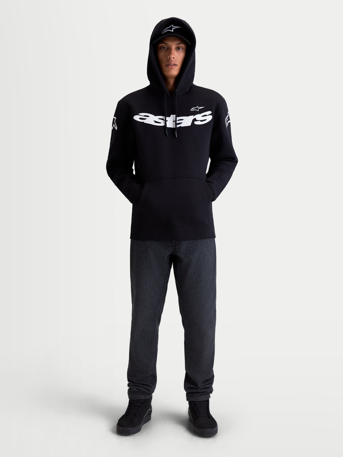 Alpinestars Velocifier Hoodie, Motorrad-Sportswear-Kapuzenpullover, Unisex, Schwarz und Weiß, Mischung aus Baumwolle und recyceltem Polyester, mit markantem Astars-Branding auf der Brust und Schulterlogos, Frontansicht am Modell für die Freizeit.