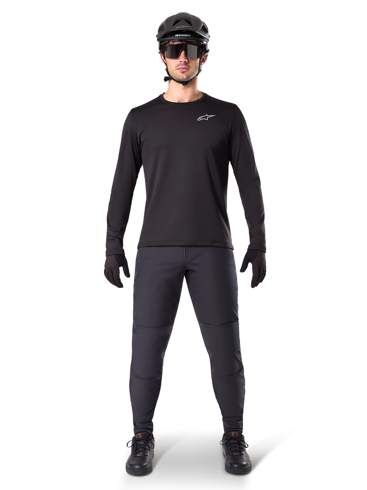 Alpinestars A-Dura Thermal Pant, Black, worn by a rider in complete mountain bike gear including a black long-sleeve jersey, helmet, and sunglasses, durable pants with a regular fit for cold-weather trail riding
