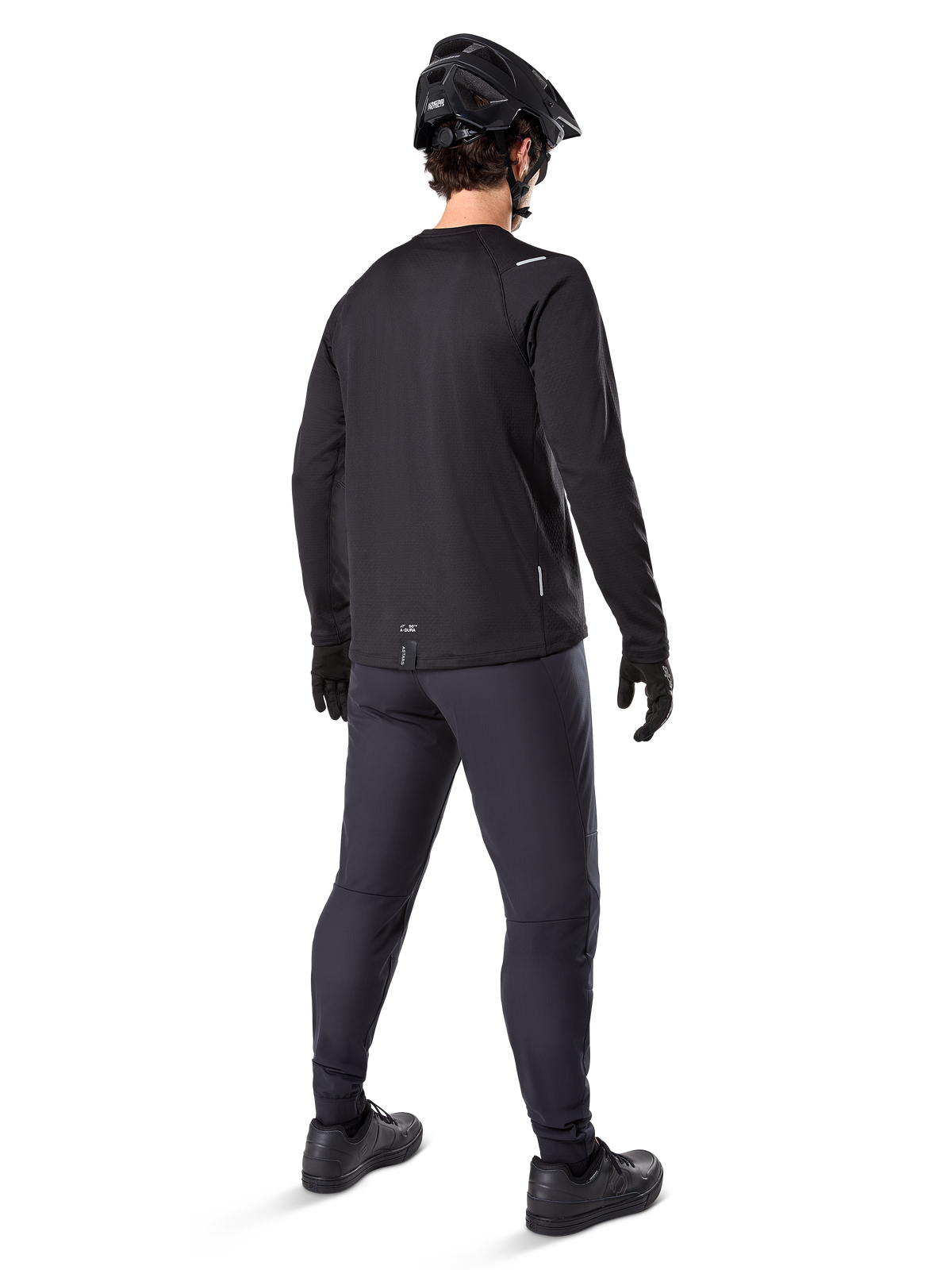 Alpinestars A-Dura Thermal Pant, Mountain Bike Pants, Black, shown from a rear perspective worn with a matching long-sleeve jersey, black MTB helmet, and gloves, technical cold-weather cycling gear