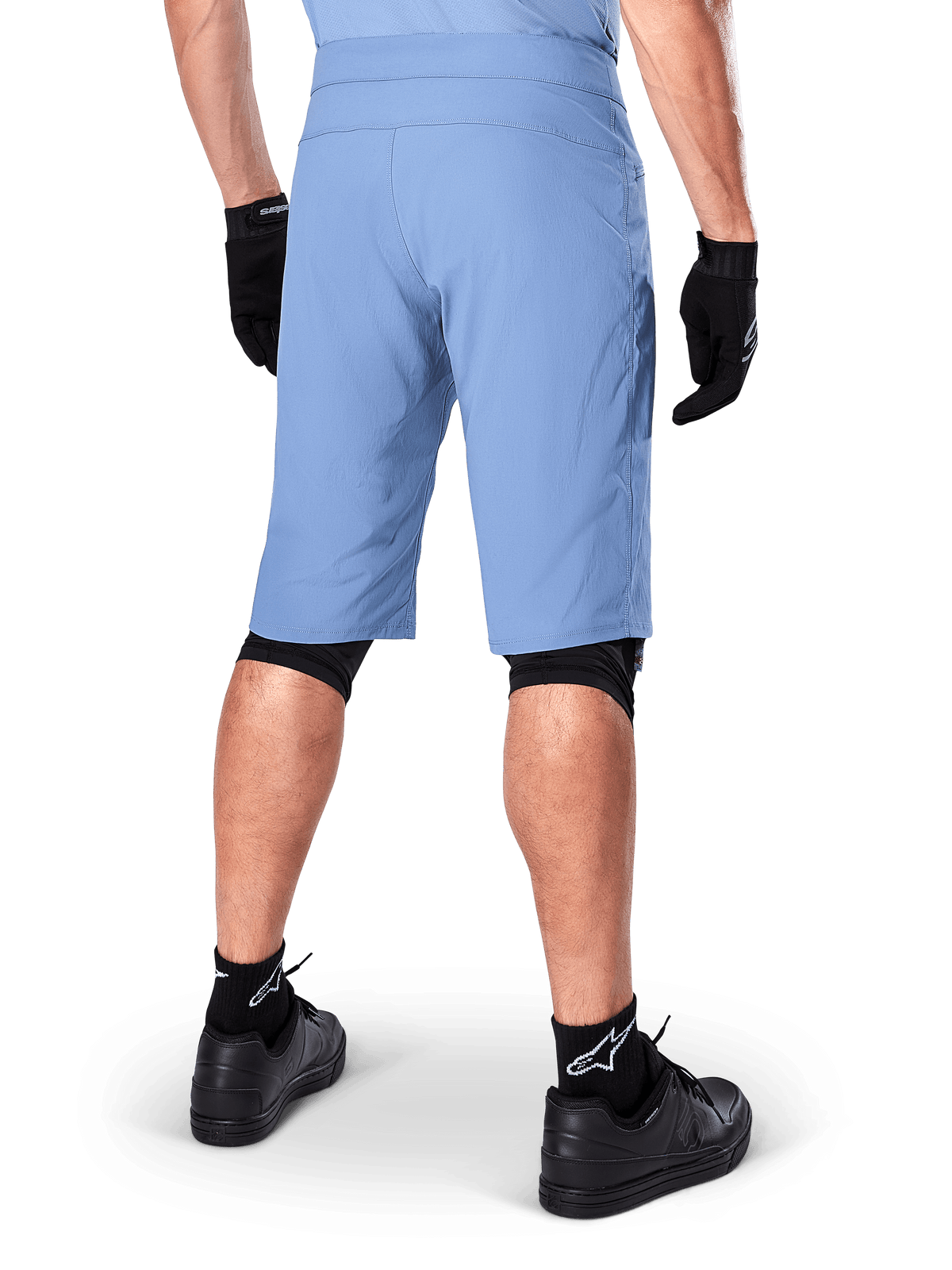 Alpinestars A-Dura Shorts, Infinity Blue mountain bike shorts, back view, paired with black gloves, knee liners, and black socks with white star logo, durable stretch material for off-road cycling