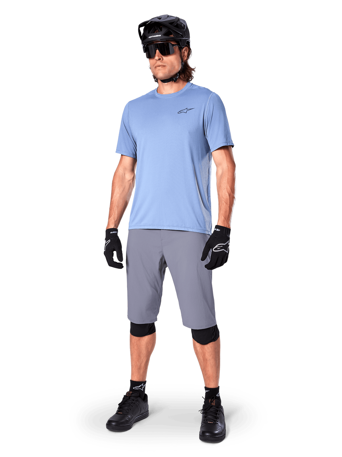 Alpinestars A-Dura Shorts, MTB Shorts, Dark Gray, worn by a rider with a light blue jersey, black MTB helmet, black gloves, and knee guards, complete mountain bike outfit for trail and off-road riding