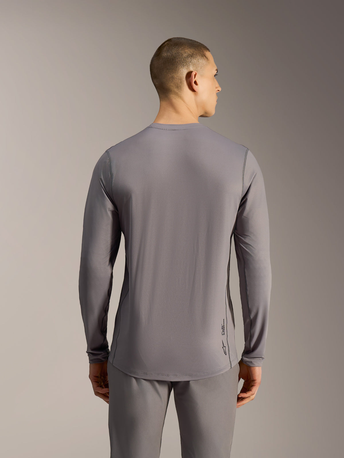 Alpinestars A-Dura Ride Langarm-MTB-Trikot, Grau, Jacquard-Stretch-Gewebe mit verlängertem Rücken, sportliche Passform.