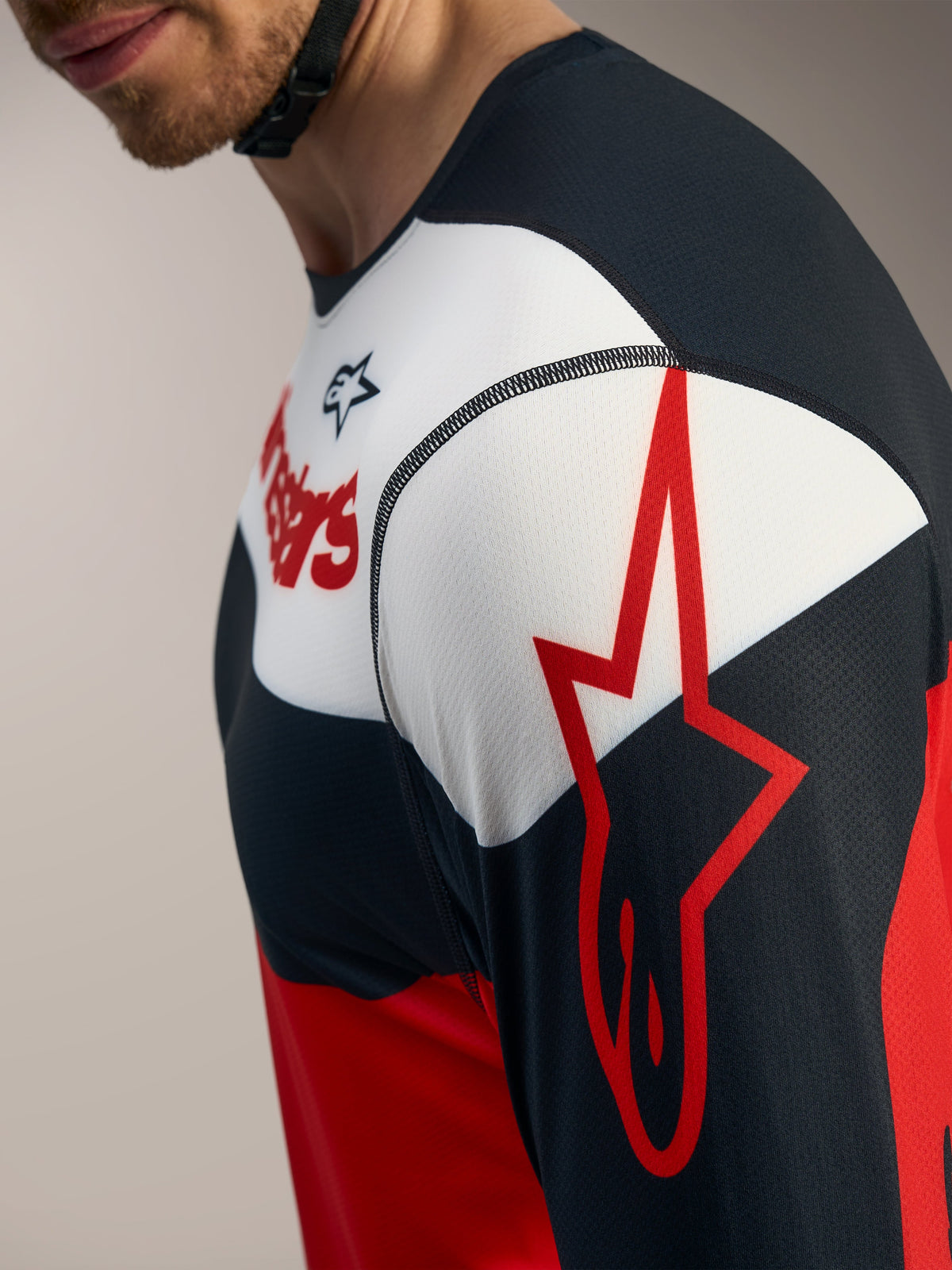 A-Dura Race Long Sleeve Jersey detail in red, black, and white with the Alpinestars star logo on the sleeve.