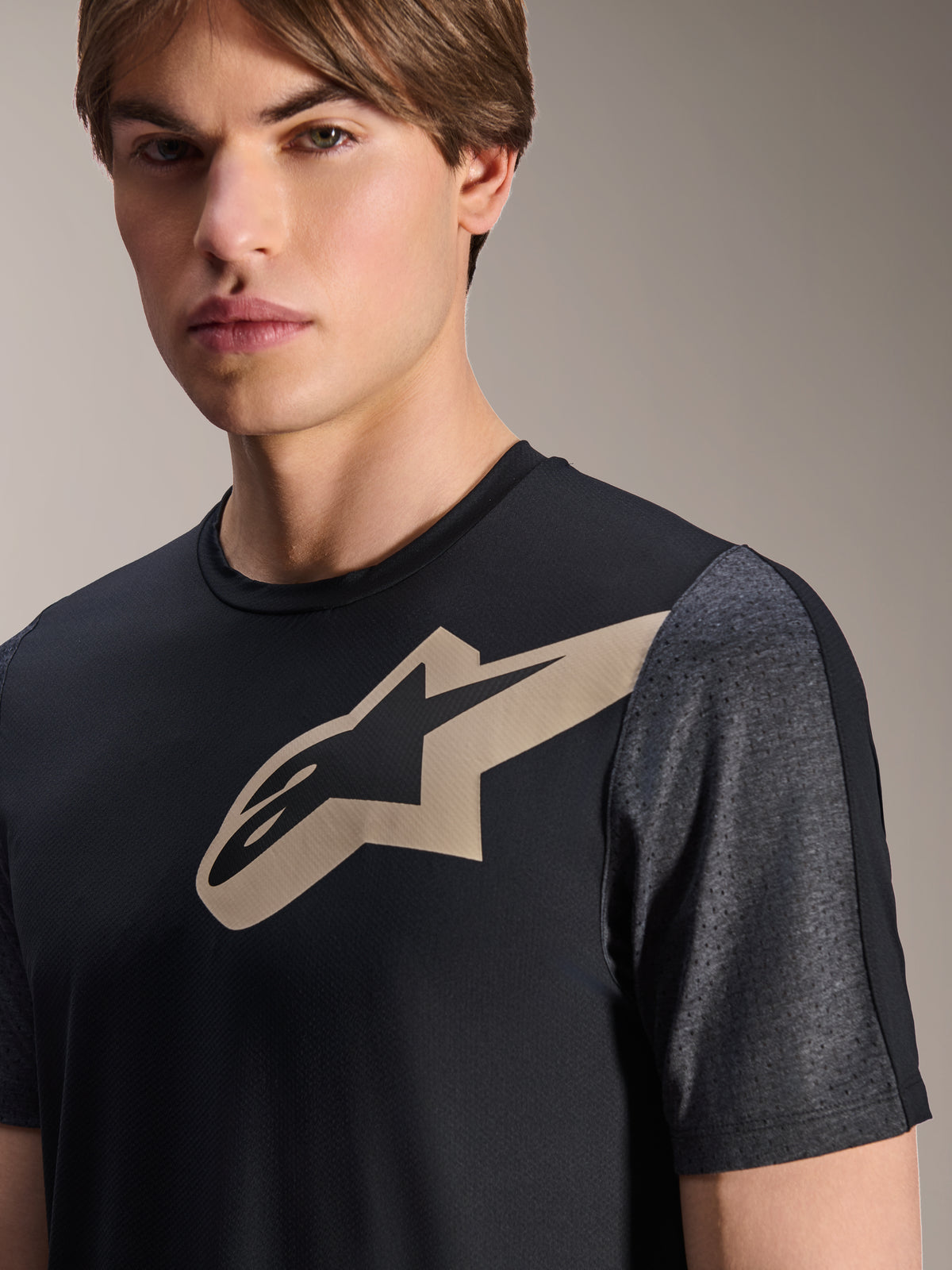 Alpinestars A-Dura Lipan Jersey - Short Sleeve, Black, featuring a tan Astars logo on the chest and dark gray heathered perforated sleeves, performance mountain bike apparel