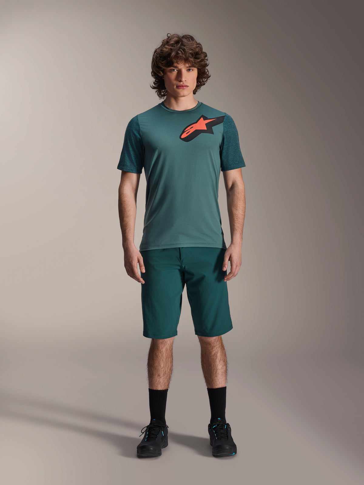 Alpinestars A-Dura Lipan Jersey, Short Sleeve MTB Jersey, Silver Pine green with black and orange Astars logo on chest, paired with matching shorts and black footwear, technical mountain bike apparel