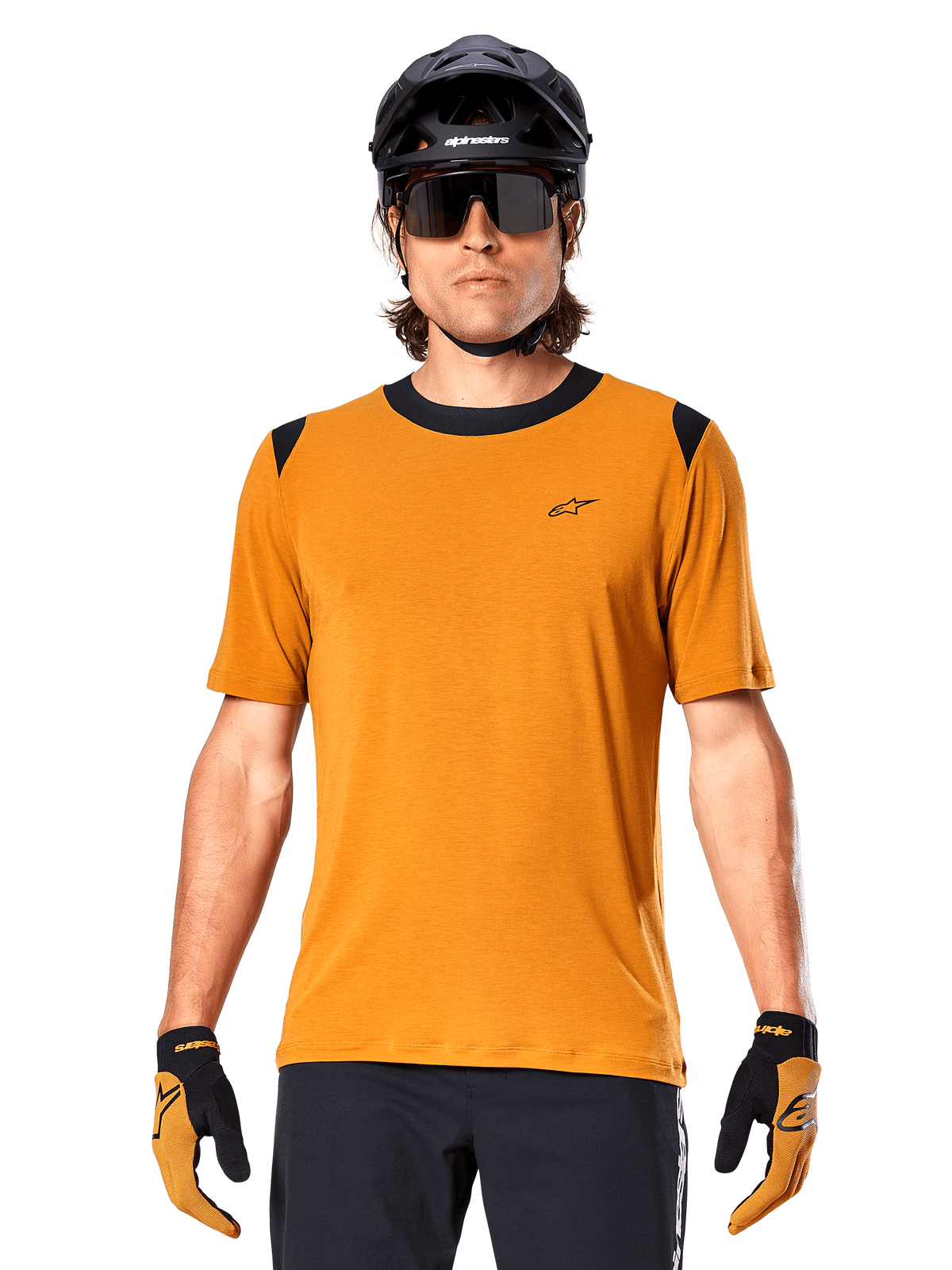 Alpinestars A-Dura Dri Wool Short Sleeve Jersey, Dark Gold, worn with black MTB helmet, sunglasses, and gloves, featuring black collar and shoulder panels, breathable drirelease wool blend for mountain biking