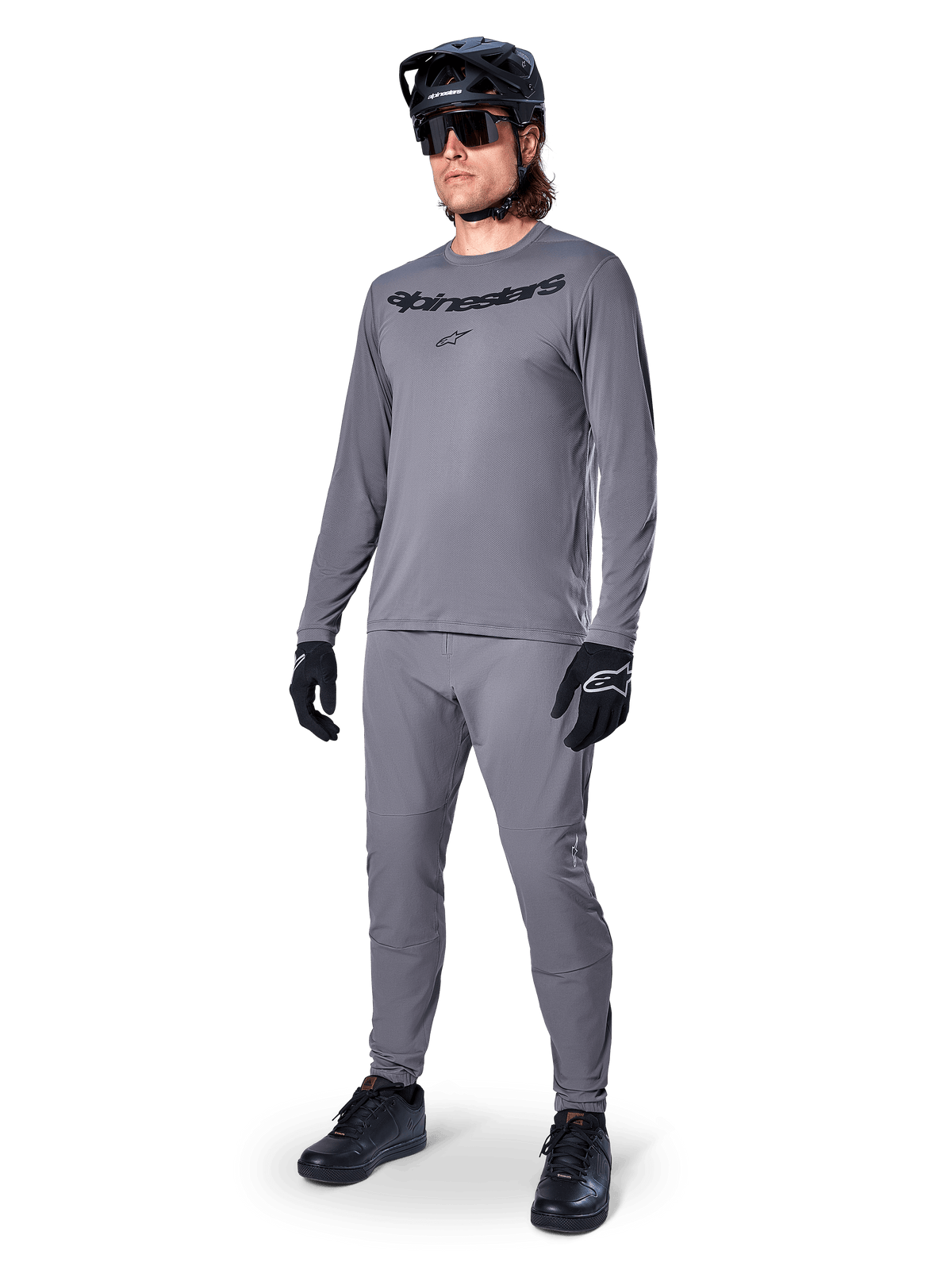 Alpinestars A-Dura Rocker Jersey - Long Sleeve, Dark Gray, worn by a model with matching gray pants, black mountain bike helmet, sunglasses, and gloves, casual MTB style for off-road riding