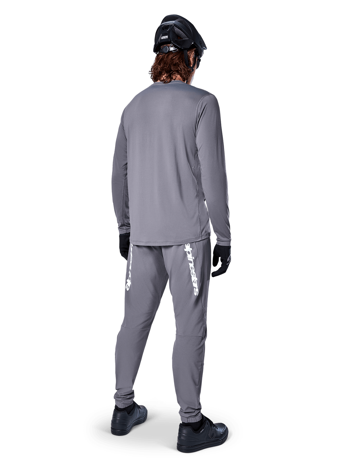 Alpinestars A-Dura Rocker Long Sleeve Jersey, Dark Gray, rear view of model wearing matching gray MTB pants, black helmet, and black gloves, professional mountain bike apparel design