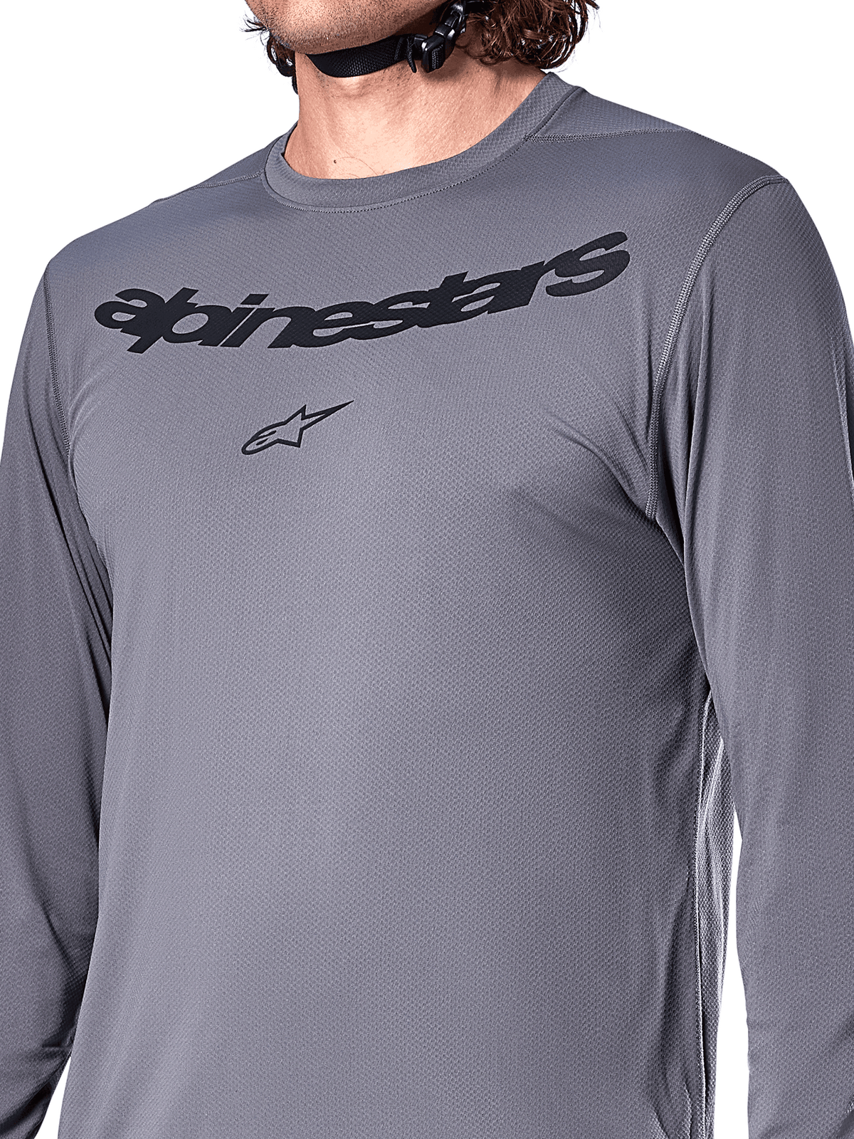 Alpinestars A-Dura Rocker Long Sleeve Jersey, Dark Gray, close-up of chest featuring black Alpinestars wordmark and star logo, jacquard poly-spandex material, performance mountain bike apparel