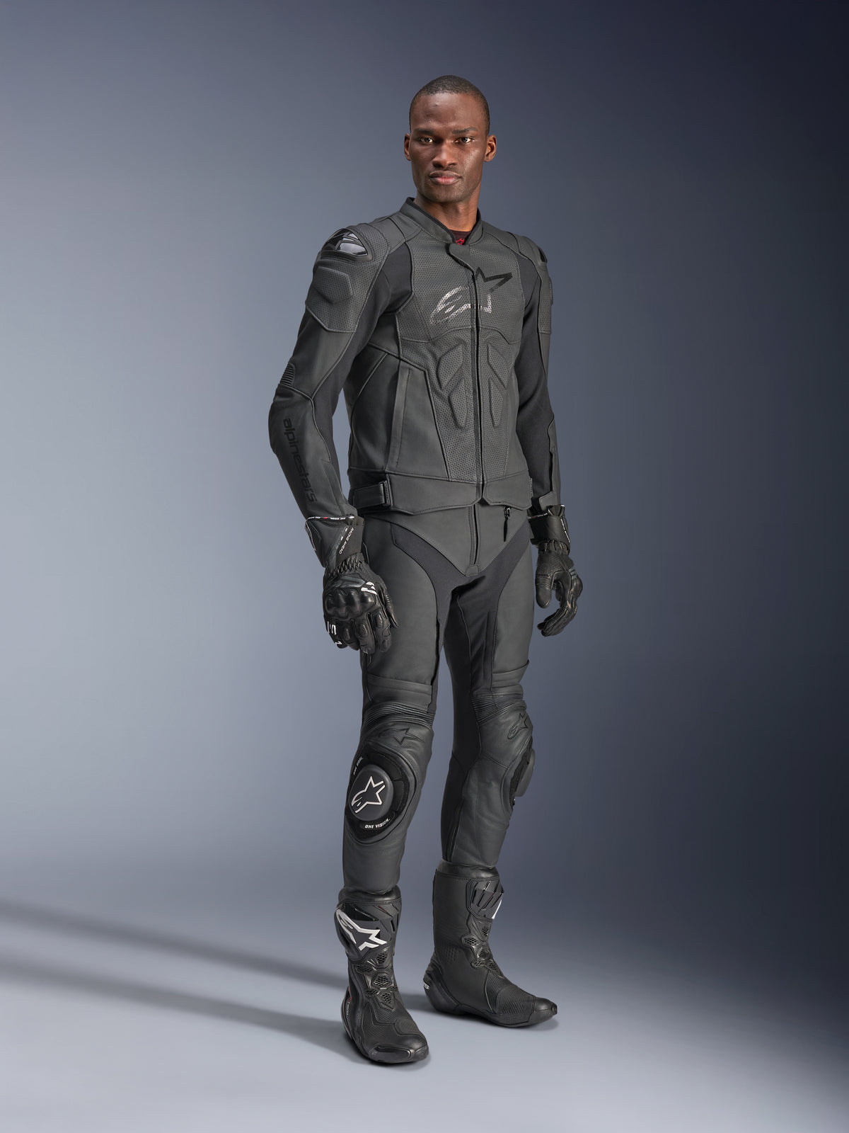 Alpinestars Dusk Airflow Leather Jacket, Black Black, worn by a rider in full technical gear including matching leather pants, gloves, and boots, featuring perforated leather panels for ventilation and integrated armor for sport motorcycle riding