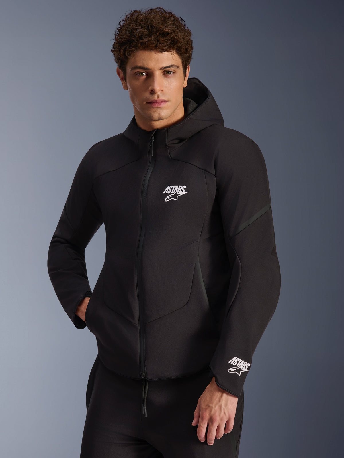 Alpinestars Aeroshell Waterproof Jacket, men's black softshell motorcycle jacket with white ASTARS logos and integrated hood.