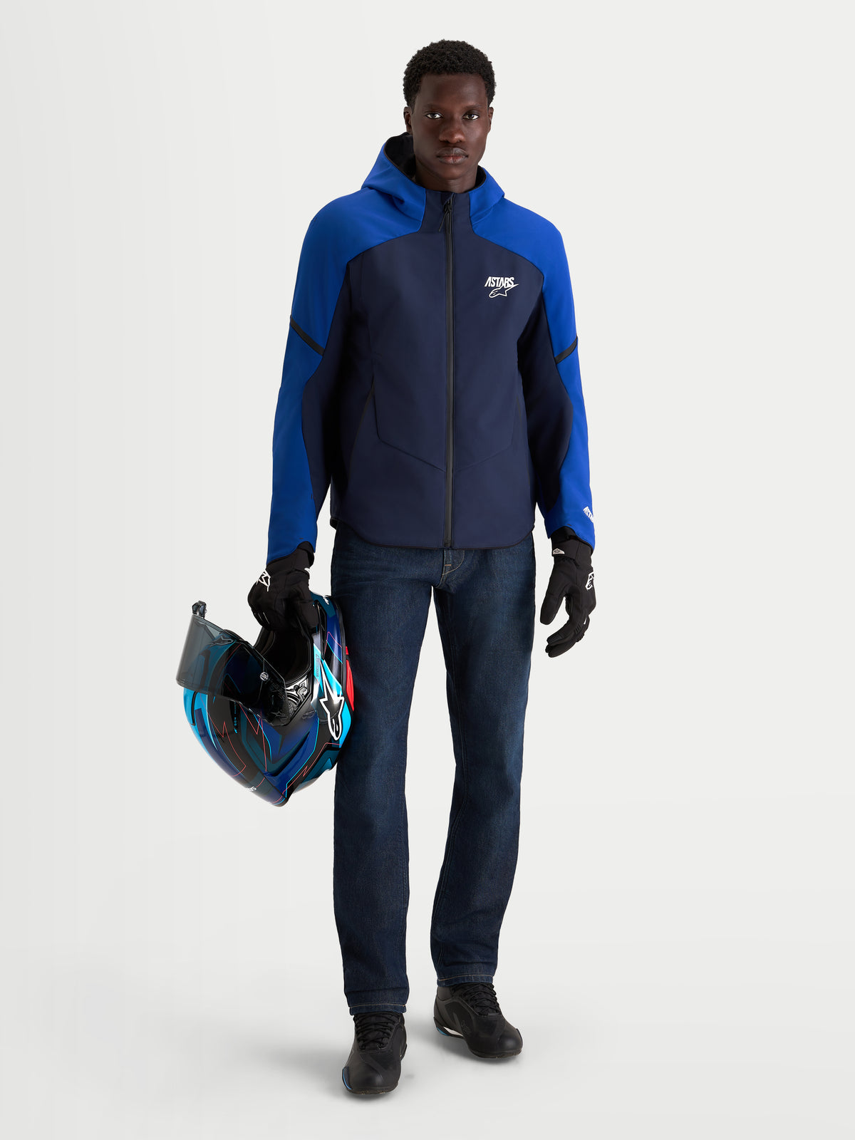 Alpinestars Aeroshell Wp Jacke, Herren-Motorradjacke in Nachtblau und Blau, Softshell-Jacke mit Kapuze, CE-zertifiziert, getragen von einem Model mit passendem Helm