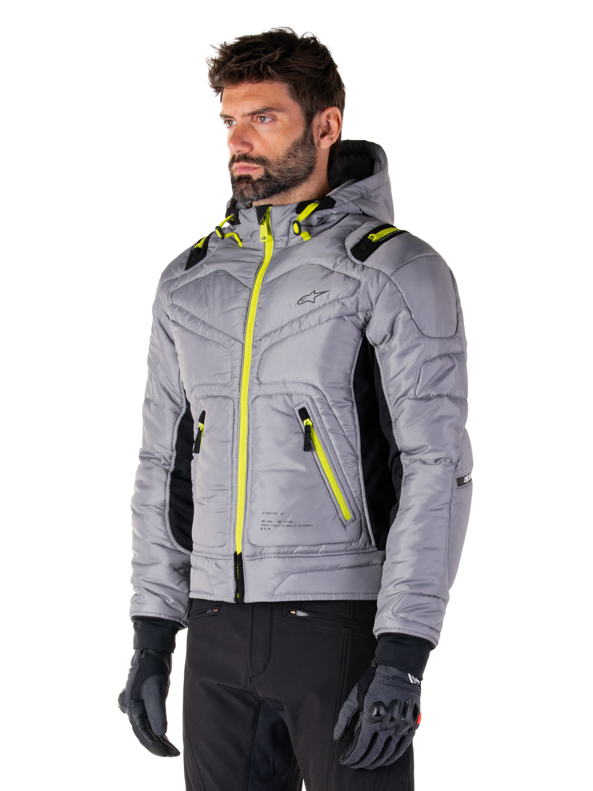 Alpinestars Mohobbs Waterproof Jacket, Lunar Gray Lime Punch, men's quilted bomber motorcycle jacket with neon yellow zippers and drawstring accents, worn with black riding pants and gloves, modern urban moto streetwear design with a hooded profile