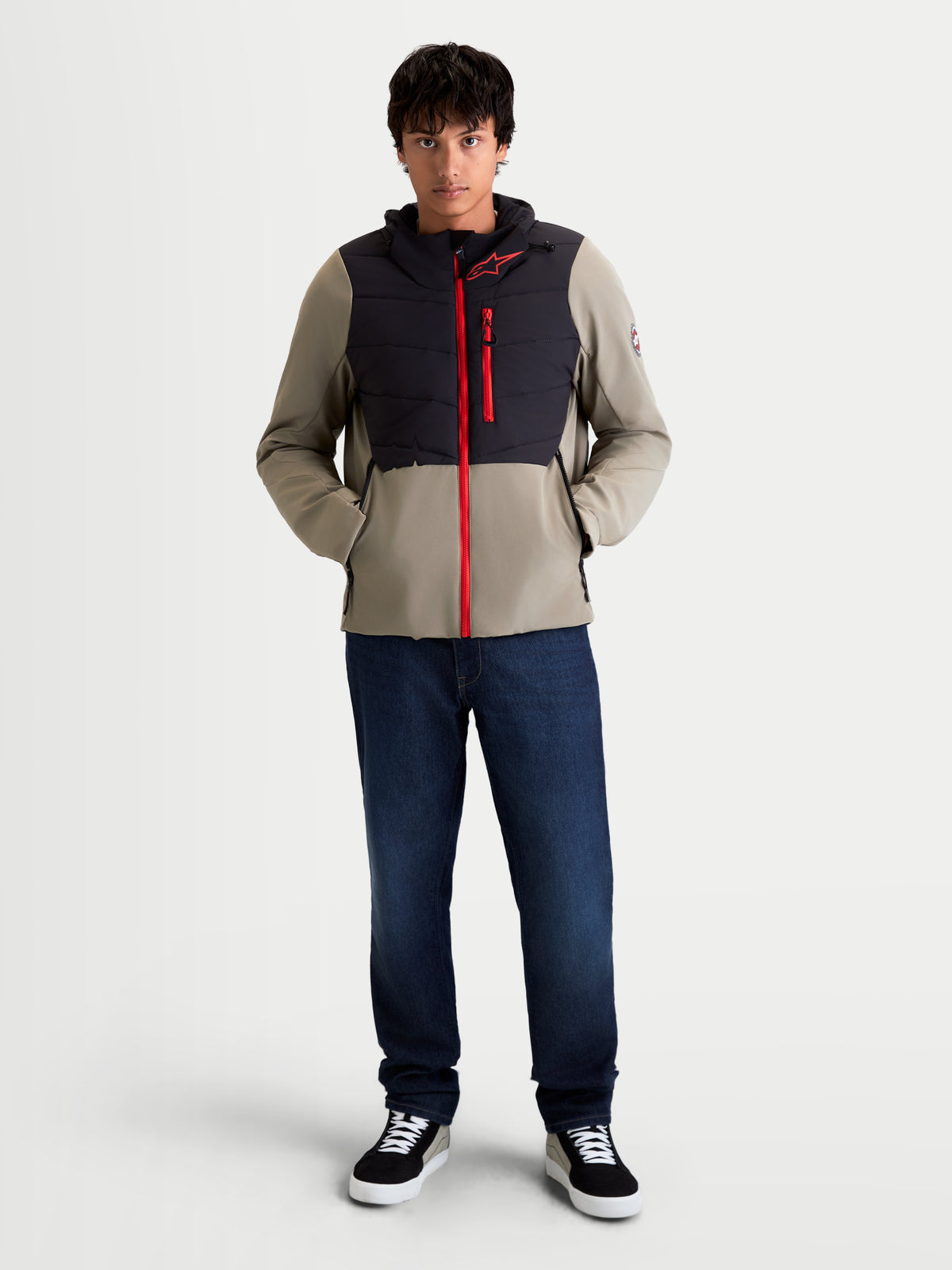 Alpinestars Therma-Tech Waterproof Jacket, men's urban contemporary motorcycle textile jacket in black and vetiver, front view on a model wearing the insulated jacket with a red front zipper and sonic-welded down chest construction