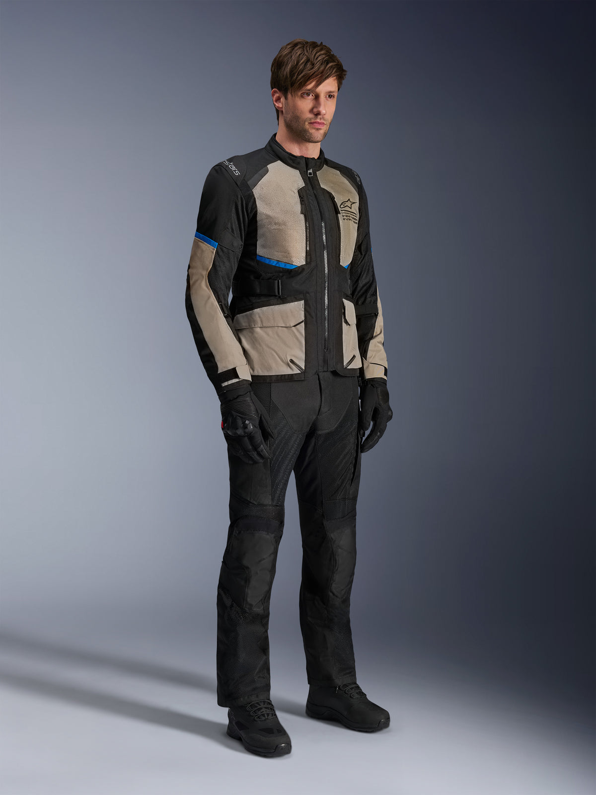 Alpinestars Andes Air Drystar® Jacket, Motorcycle Touring Jacket, Black Laurel Gray and Bright Blue, worn with matching riding pants and gloves, featuring extensive mesh panels for airflow and a road-oriented fit, adventure touring gear