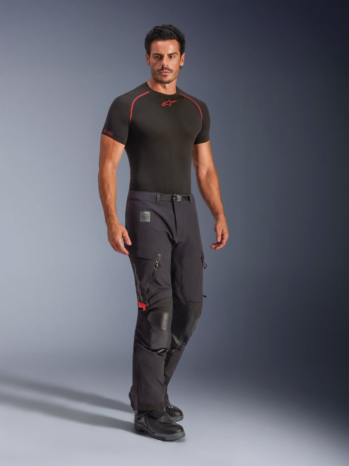 Alpinestars Halo Pro Drystar® XF Laminated Pants, Black Dark Shadow, adventure motorcycle pants worn with a black base layer and boots, featuring large zippered thigh vents, leather knee reinforcements, and a magnetic buckle belt, designed for all-terrain performance