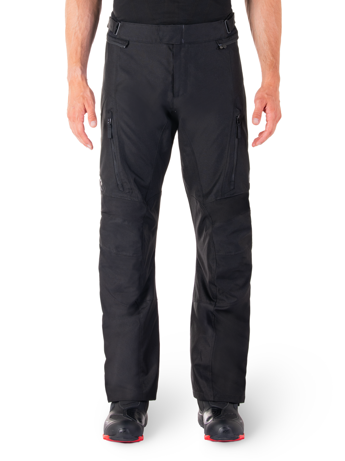 Alpinestars ST-1 Waterproof Pants, Black Motorcycle Touring Pants, front view featuring vertical zippered thigh pockets and adjustable waist tabs, worn with black red-soled boots, plain white background