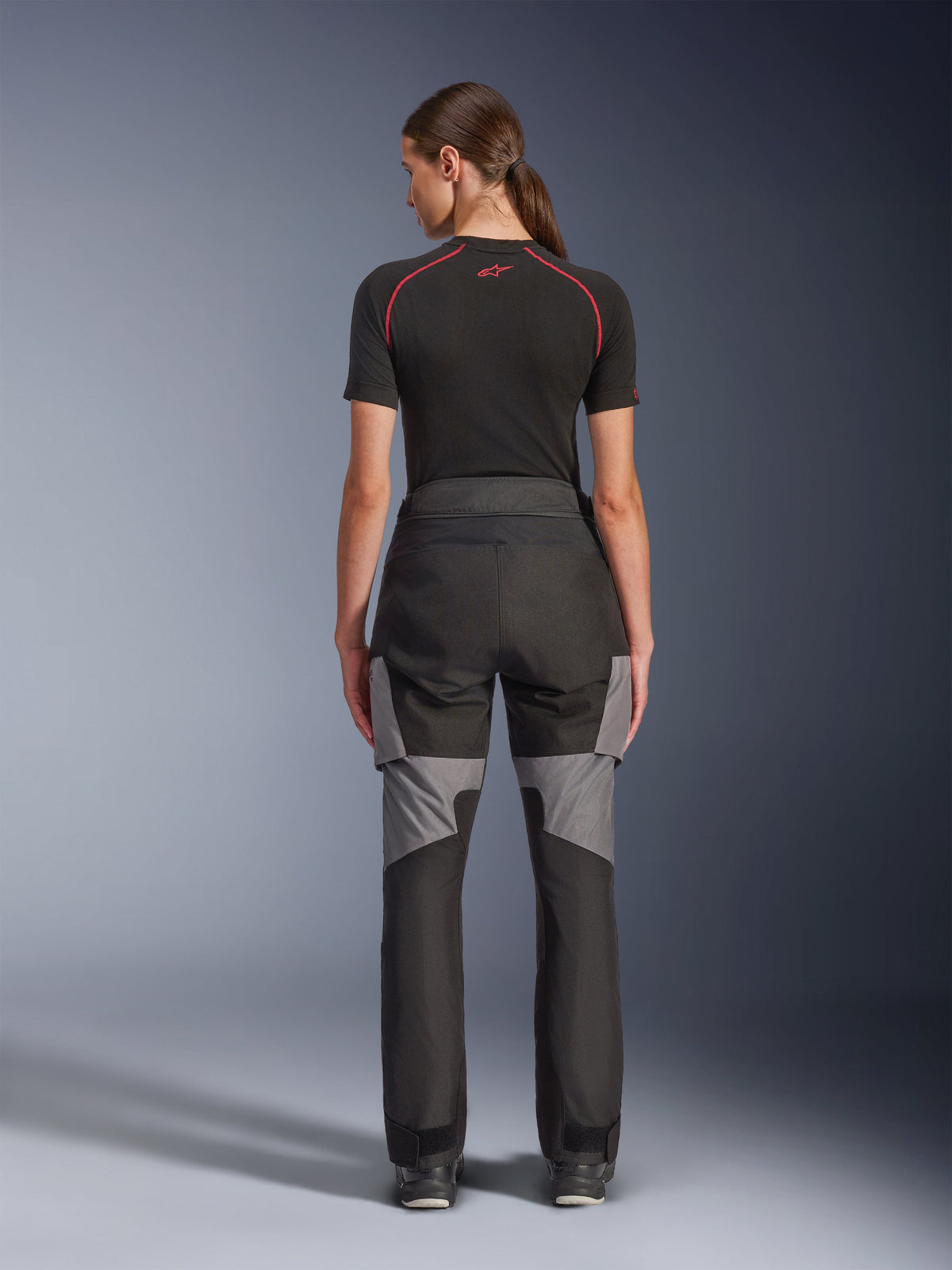 Alpinestars Stella Andes V4 Drystar® Pants, Women's Motorcycle Pants, Black and Dark Gray, back view showing gray ripstop reinforcements and ergonomic design, worn with a black technical base layer, adventure touring riding gear