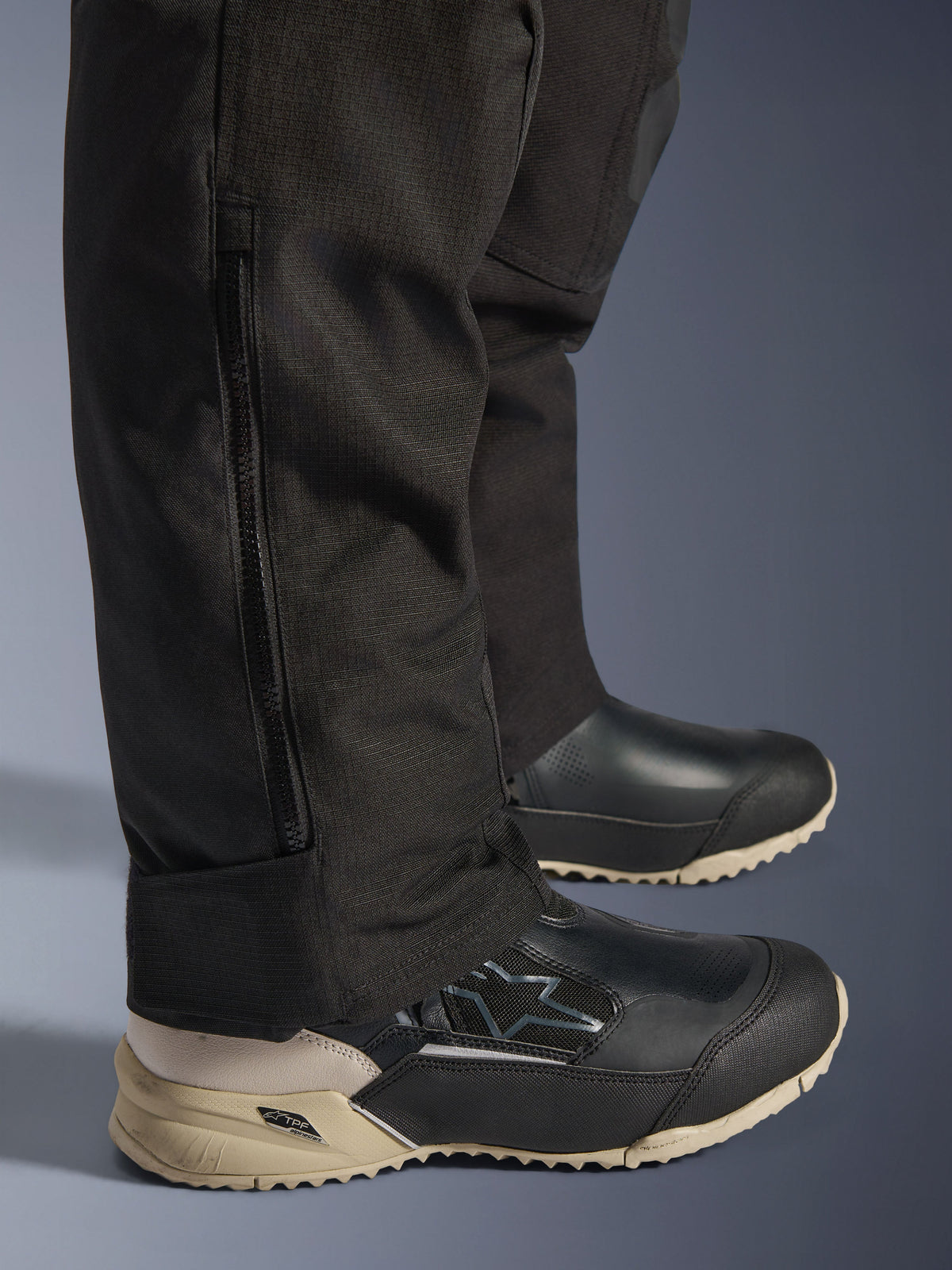 Alpinestars Stella Andes V4 Drystar® Pants, Black lower leg detail showing vertical side zipper for boot fitment, durable textile fabric construction, adventure motorcycle riding gear for women.