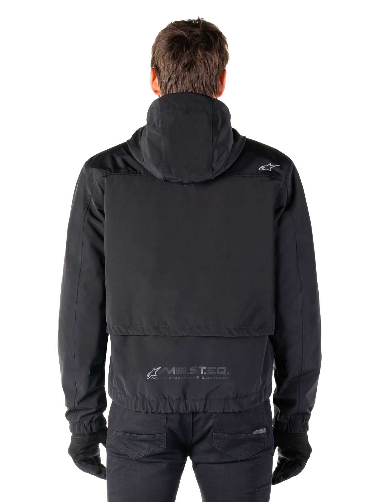 Alpinestars Mootant Waterproof Parka, Black Motorcycle Jacket, rear view showing hooded design, featuring small Astar logo on the shoulder and MO.ST.EQ. reflective branding on the lower back