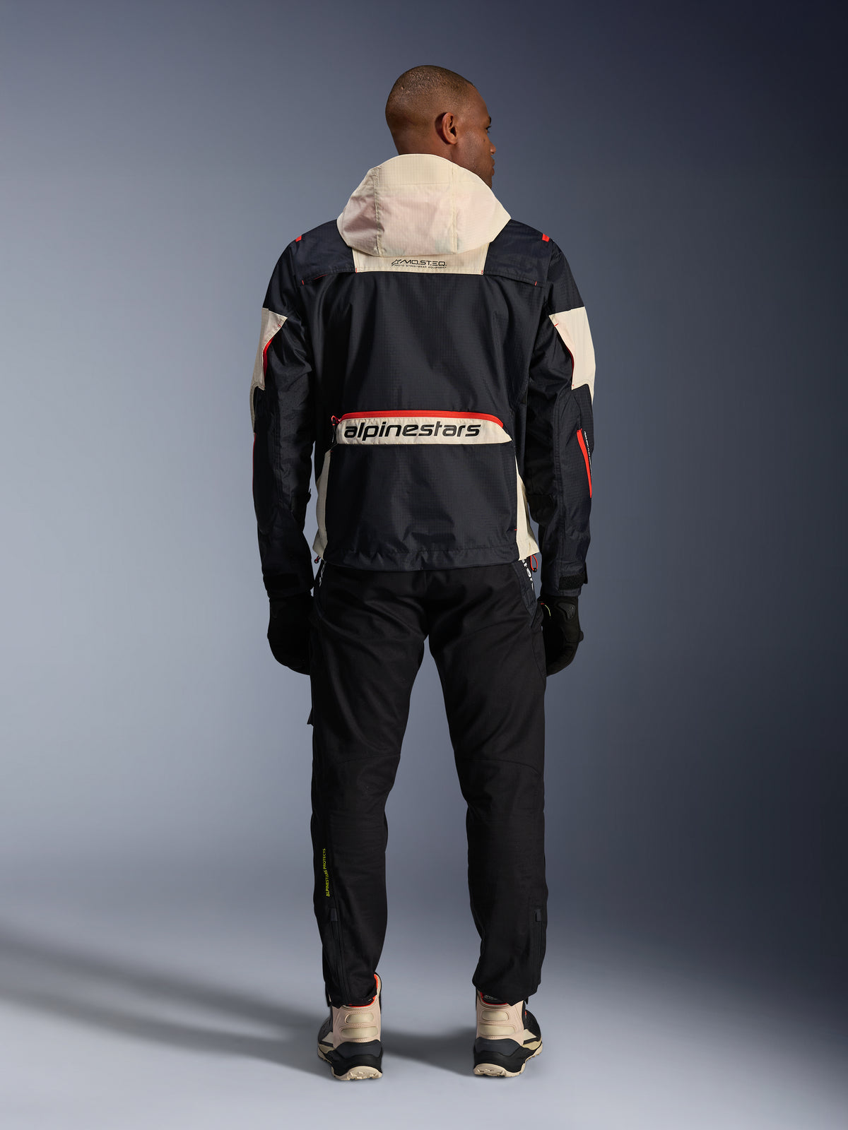 Alpinestars Mogress Air Jacket, rear view of a Men's Black and Hot Orange urban motorcycle jacket with a cream hood.