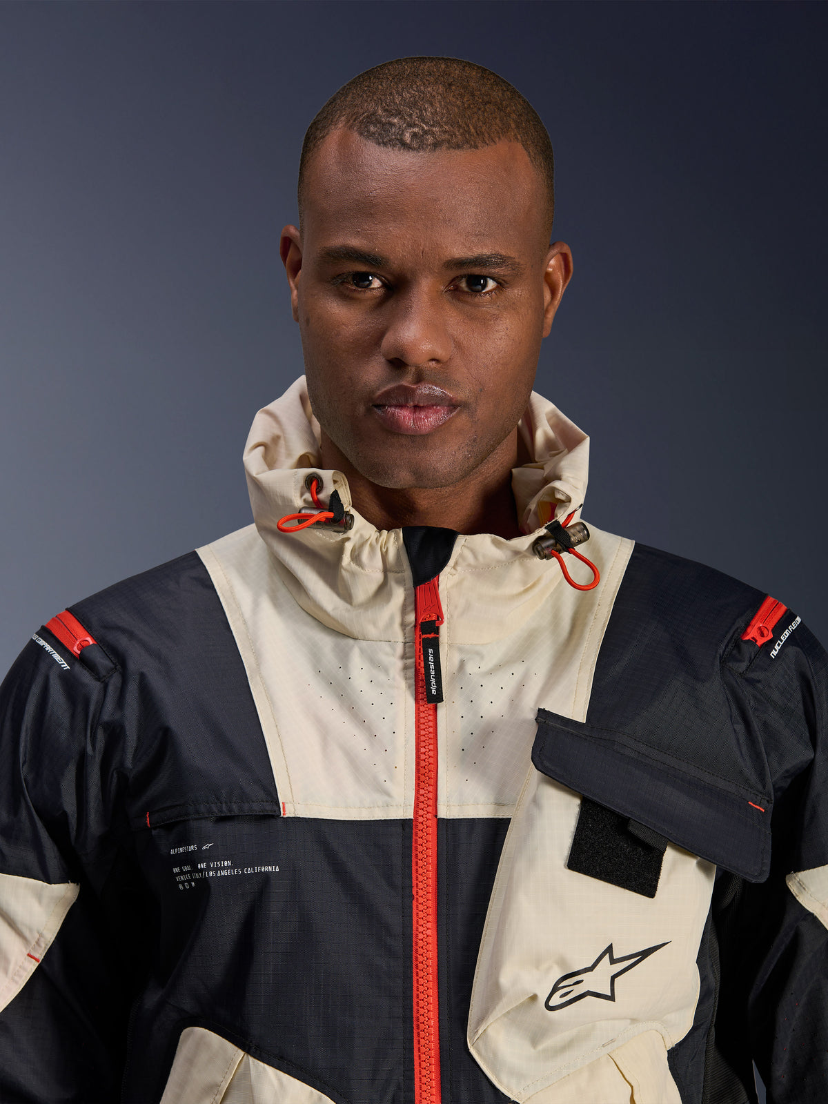 Alpinestars Mogress Air Jacket, Men's Urban Motorcycle Jacket, Black and Hot Orange ripstop textile with hood.
