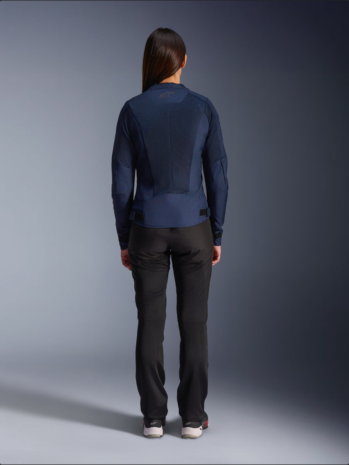 Alpinestars Stella C-1 Air Jacket, Women's Textile Motorcycle Jacket, Navy Blue, rear view featuring extensive mesh panels for ventilation and Alpinestars logo on the neck, paired with black riding pants for a modern urban look