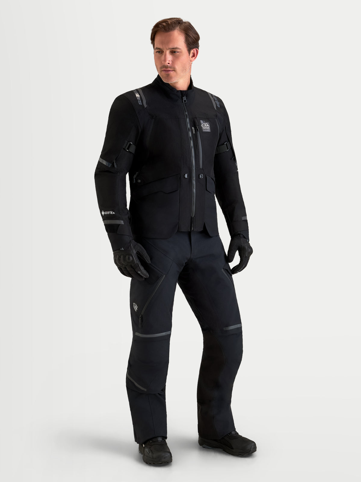 Alpinestars St-7 V2 2L Gore-Tex Jacket and Pants, men's all-terrain adventure touring motorcycle gear set in black, full-length view on a male model wearing waterproof textile apparel and gloves