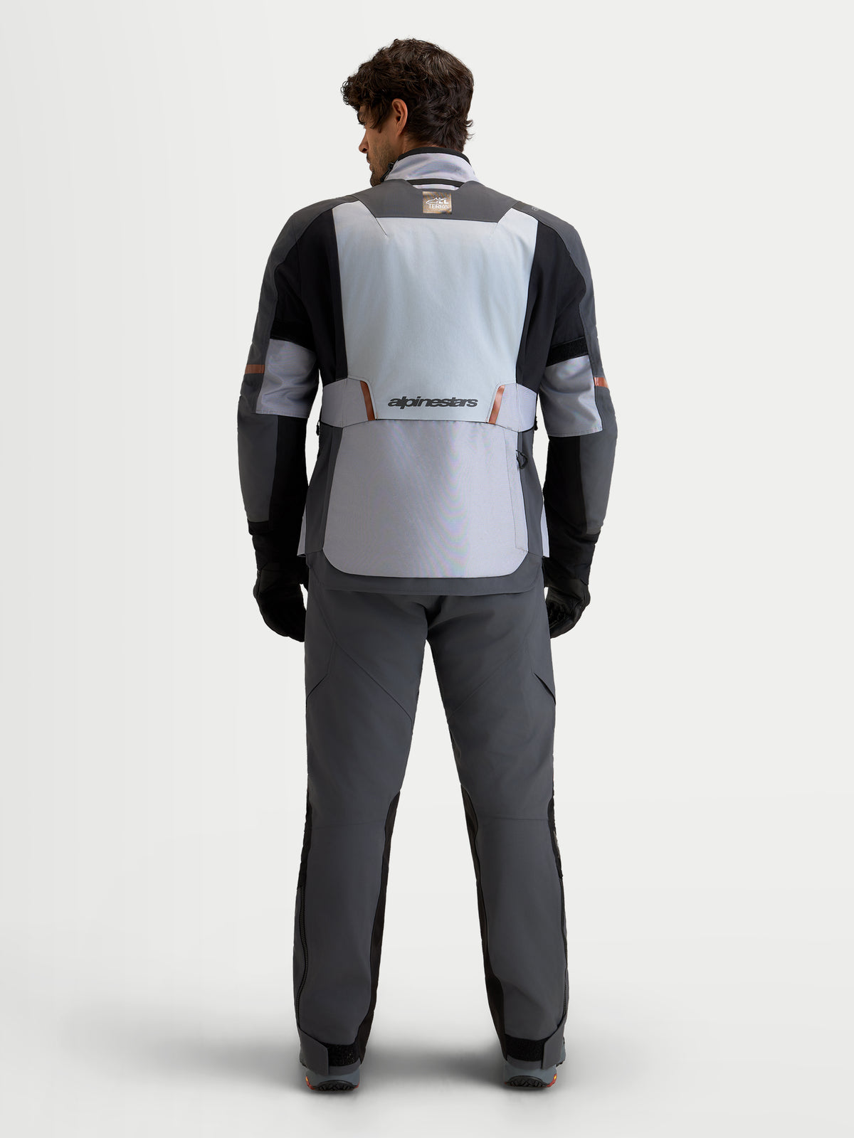 Alpinestars St-7 V2 2L Gore-Tex Jacket, Men's Adventure Touring Motorcycle Jacket, Mid Gray, Deep Gray, and Black, rear view on model showing waterproof textile construction and stretch panels