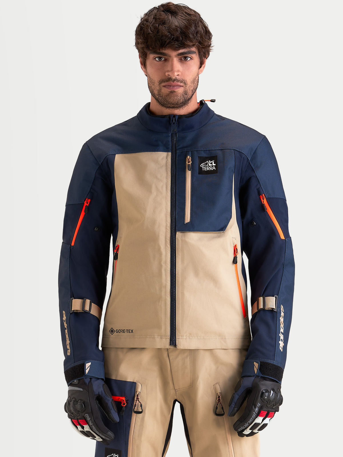 Alpinestars Arenis Gore-Tex Jacket, men's adventure touring motorcycle jacket in night navy and aluminum, front view on a model wearing matching gear and gloves, waterproof textile construction