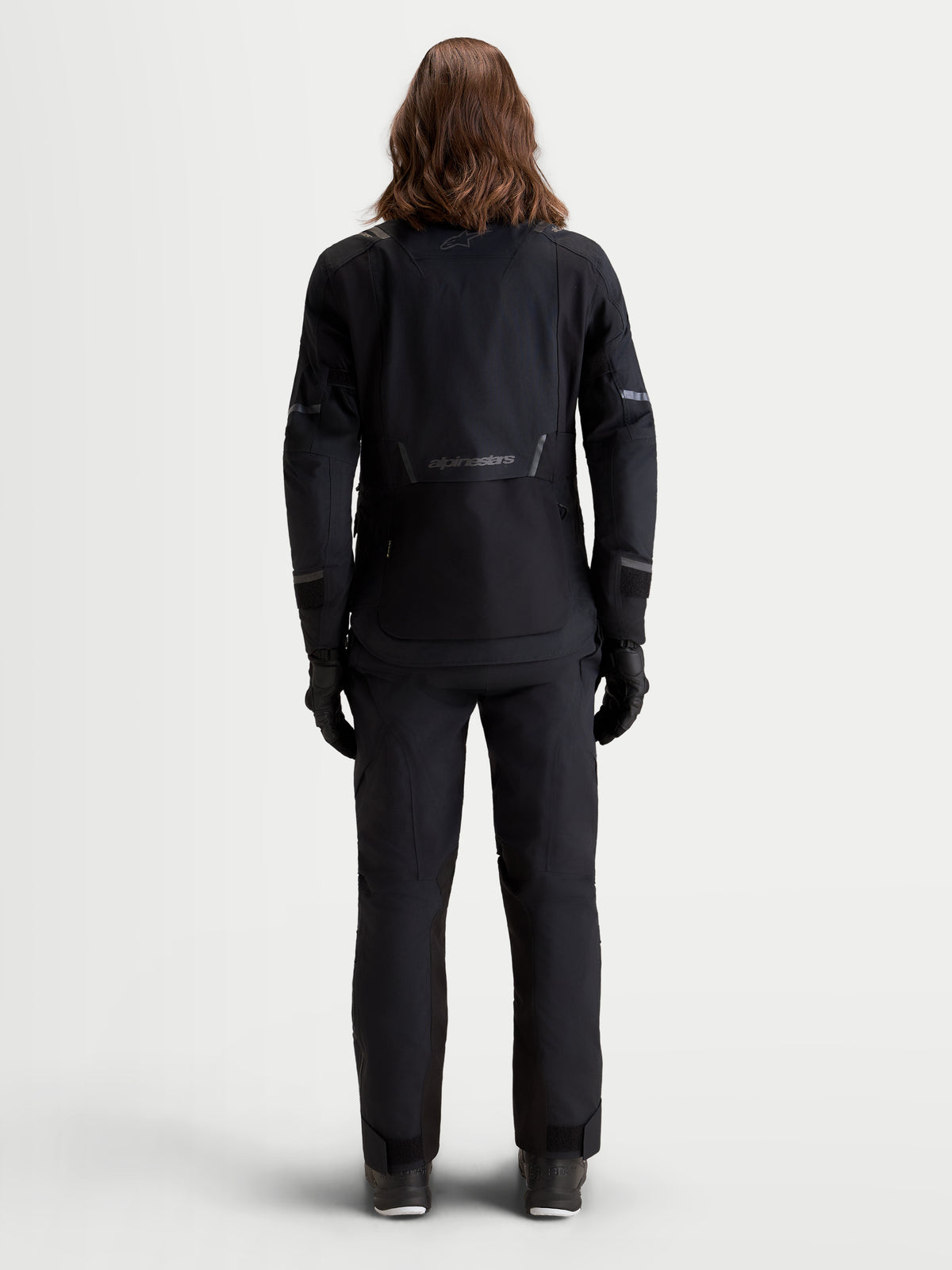 Alpinestars Stella ST-7 V2 2L Gore-Tex® Jacket, women's adventure touring motorcycle jacket in black, rear view on a model showing waterproof textile construction and reflective details.