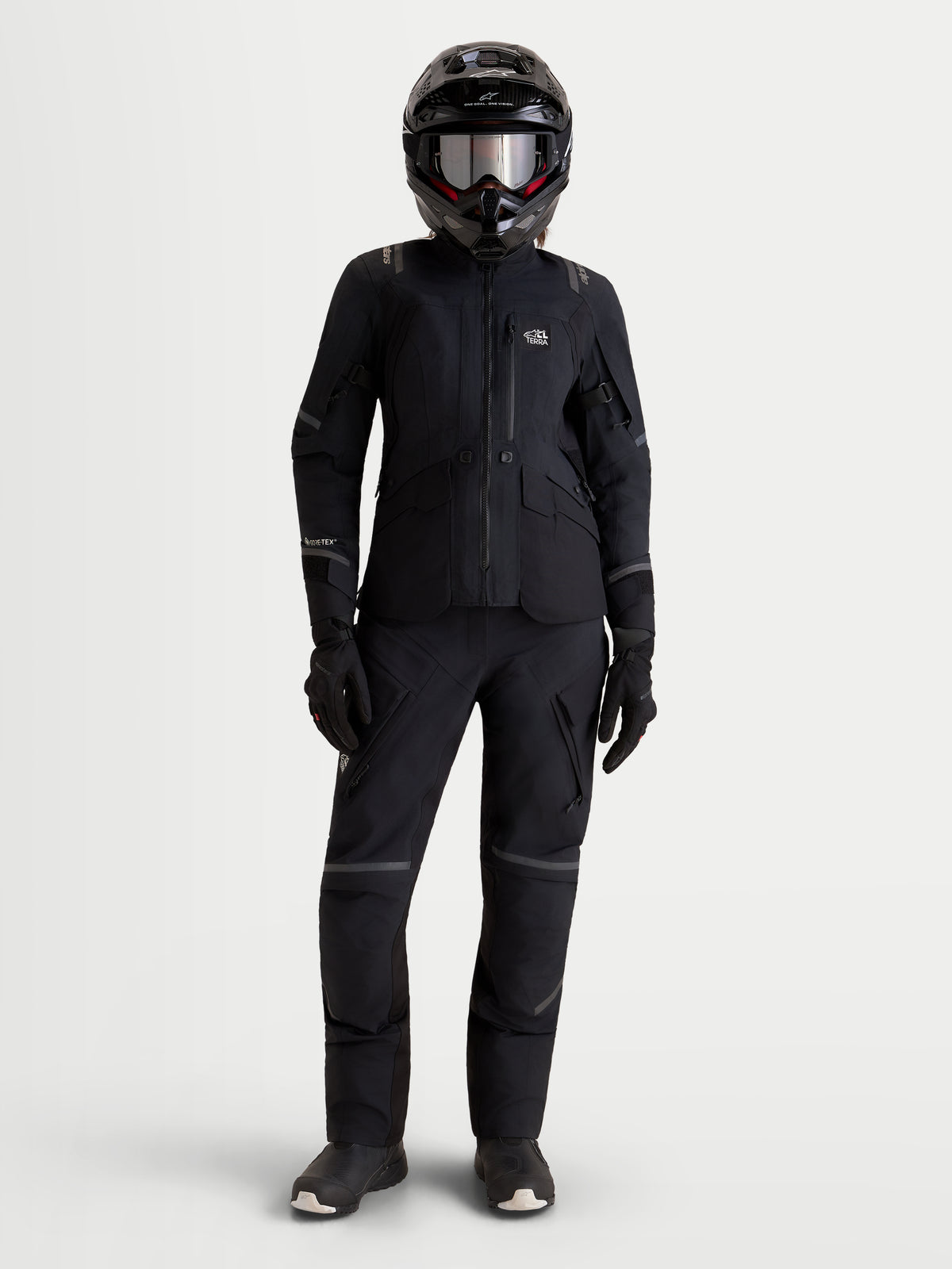 Alpinestars Stella ST-7 V2 2L GORE-TEX Jacket, women's adventure touring motorcycle jacket in black, front view on a model wearing matching gear and helmet, AA certified waterproof all-terrain riding apparel.