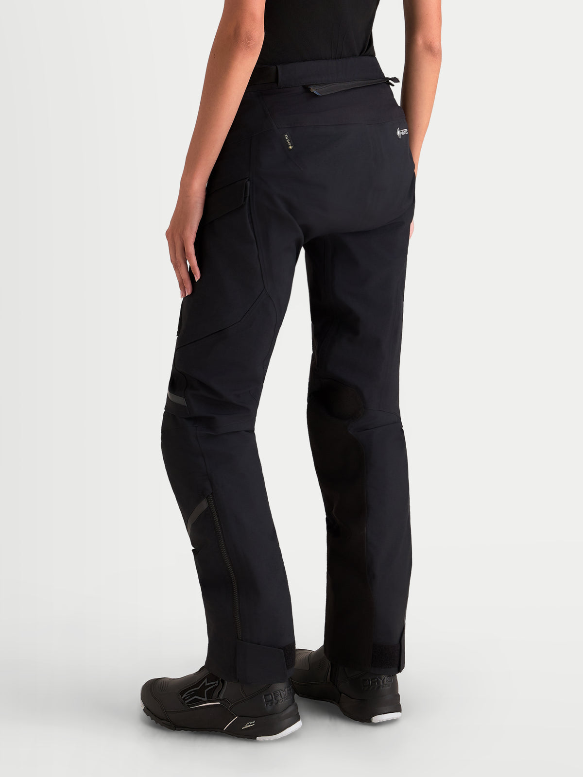 Alpinestars Stella St-7 V2 2L Gore-Tex Pants, women's adventure touring motorcycle pants in black, rear profile view on a model wearing waterproof textile riding gear