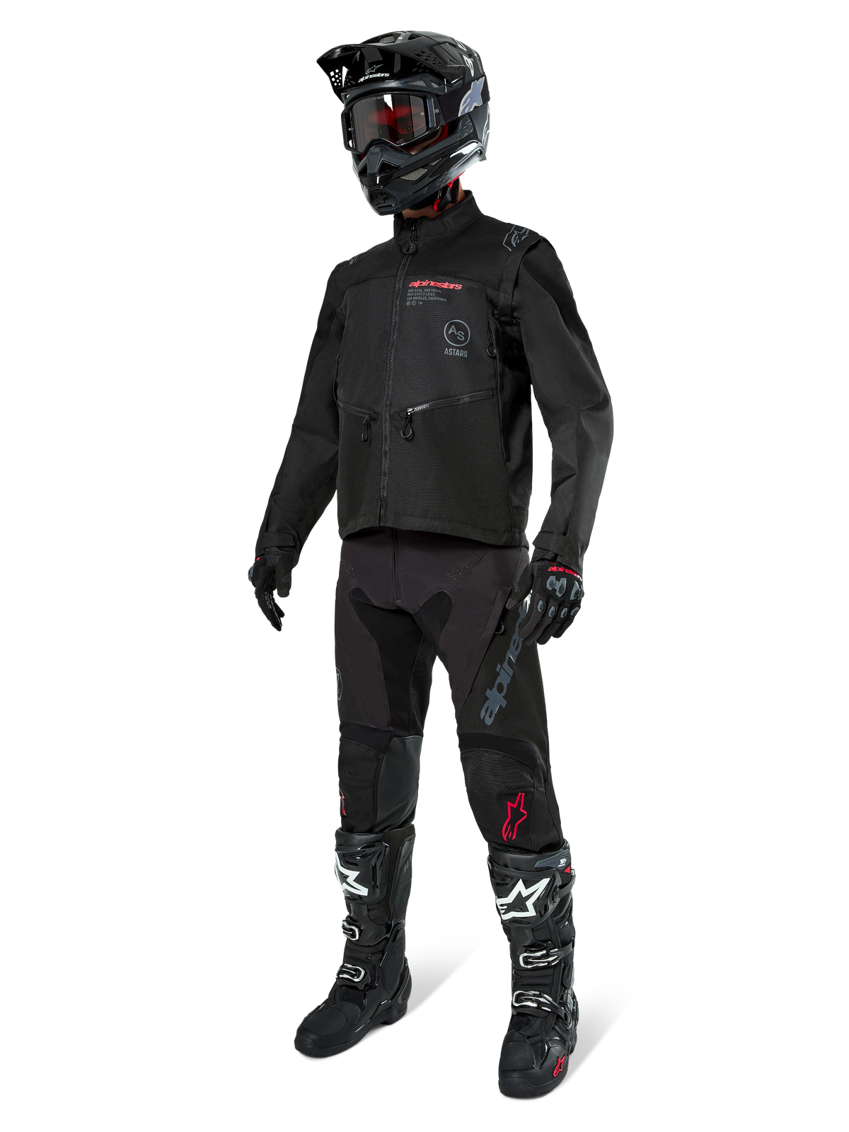 Motocross-Fahrer in kompletter Rennausrüstung, Alpinestars Pro-Dura Jacke in Schwarz, schwarze Hose mit grauem Branding und roten Akzenten, schwarzer Helm mit Goggles und schwarz-weiße Motocross-Stiefel, koordiniertes Outfit für Enduro- und Offroad-Fahrten
