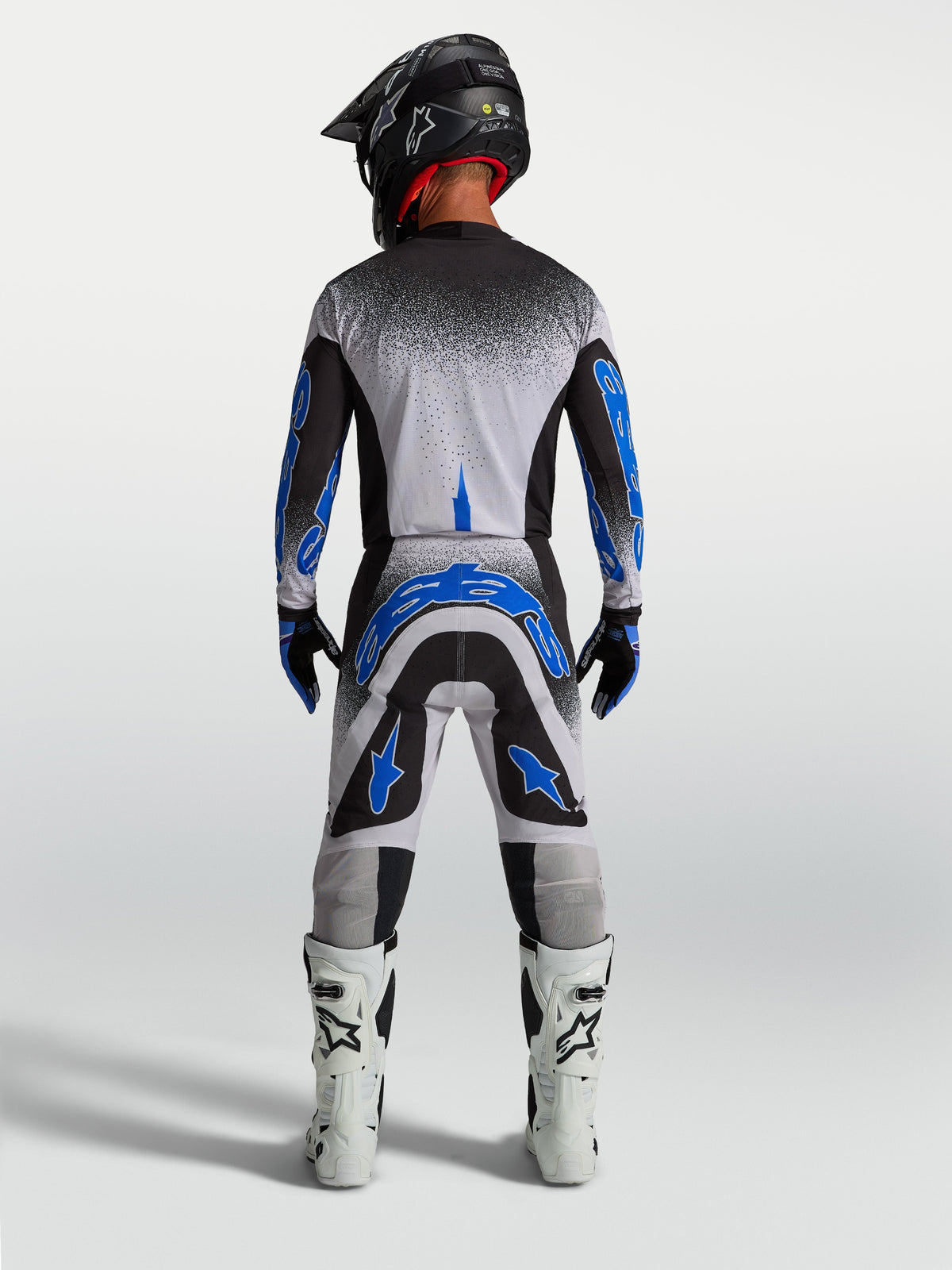 Alpinestars Supertech Hiten AFD Pants, men's motocross racing gear in blue and white, athletic rear view.