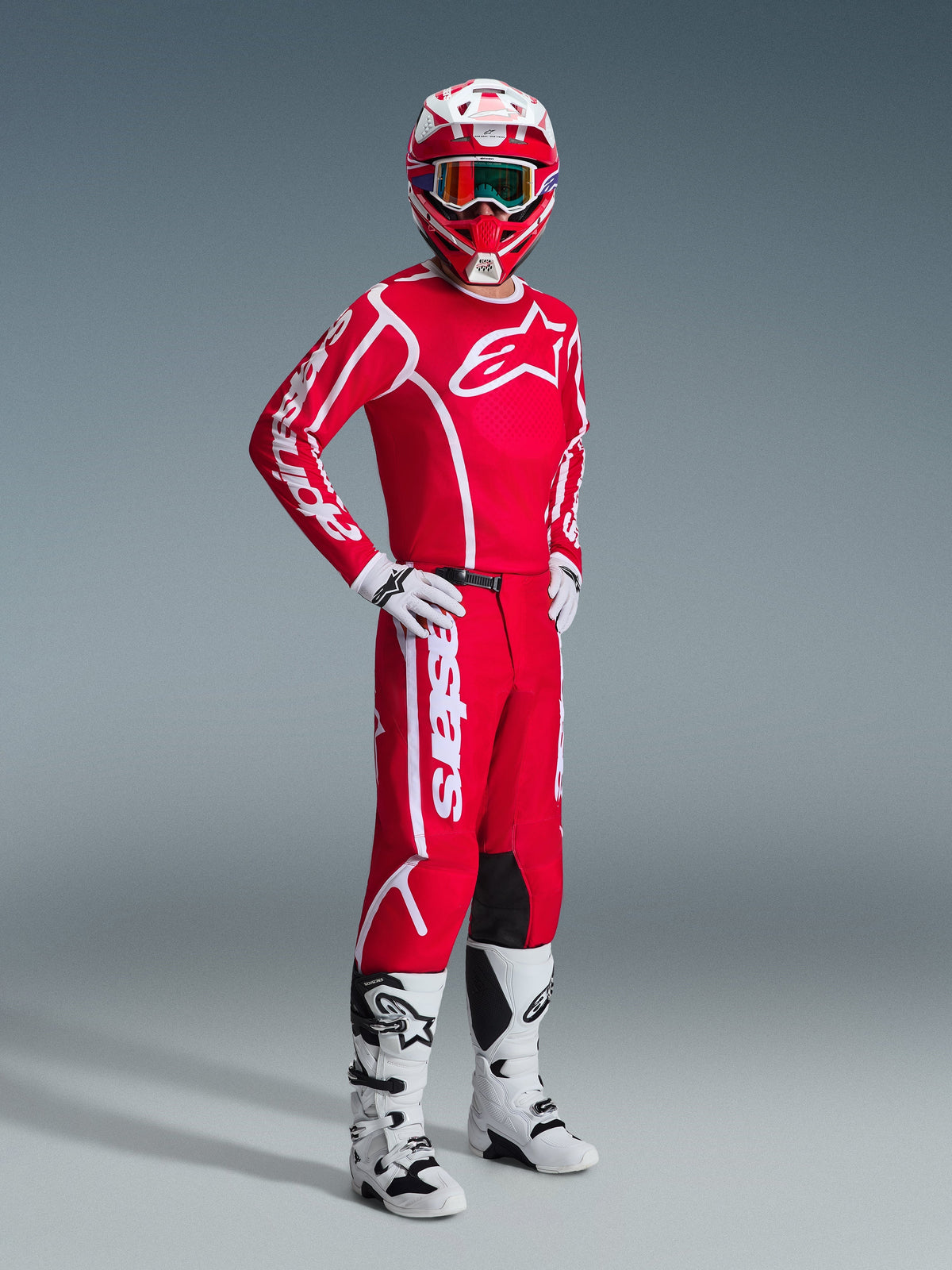 Alpinestars 2026 Fluid Apex Pants, Motocross Pants, Red and White, worn as part of a complete racing gear set with matching jersey, helmet, white boots, and gloves, coordinated outfit for off-road racing