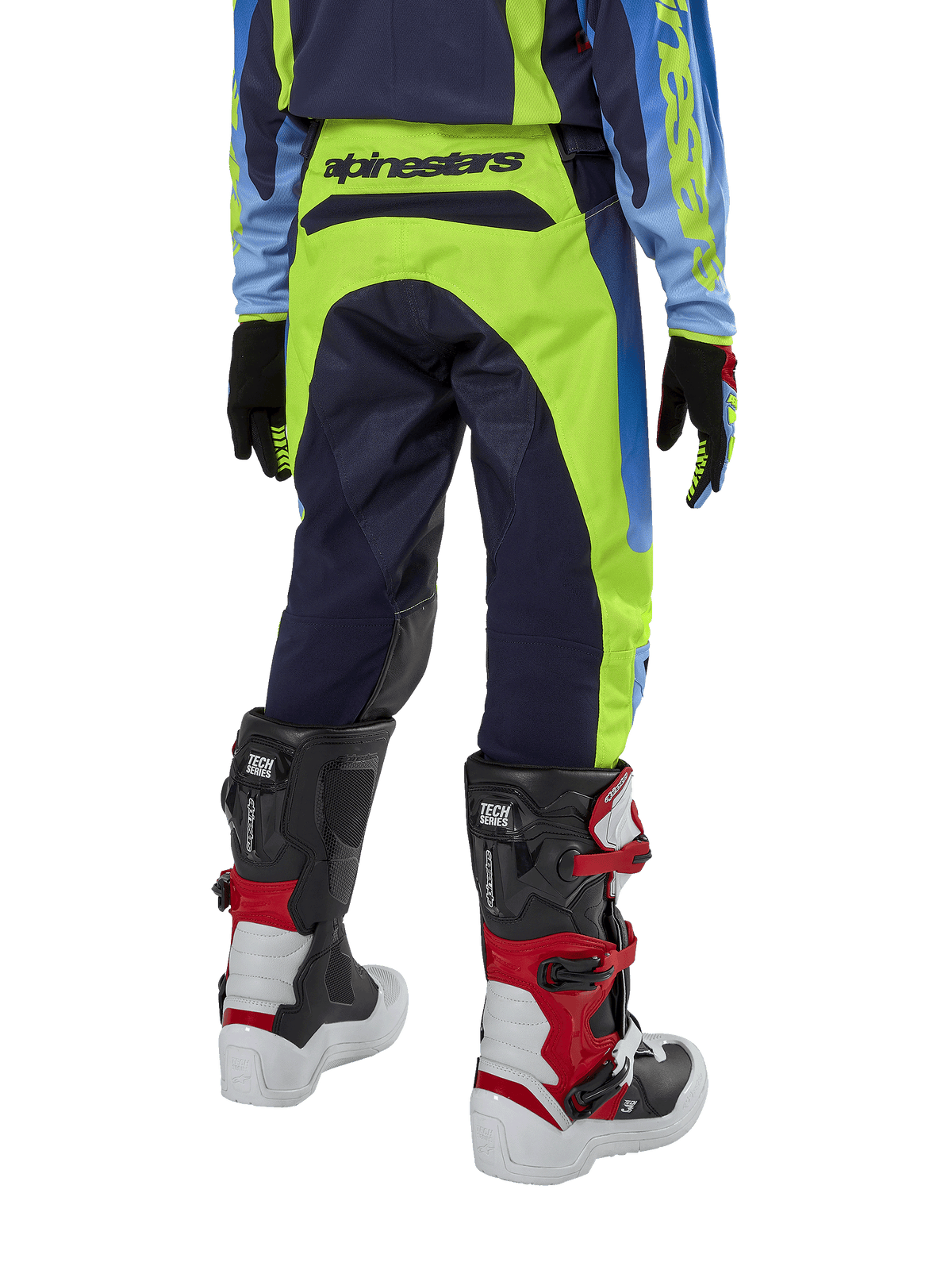 Alpinestars Youth 2024 Racer Hoen Hose, Motocross-Hose, Gelb Fluo und Blue Night Navy, Rückansicht mit markantem Alpinestars-Branding am Bund, getragen mit schwarz-roten Tech Series Stiefeln und passendem Trikot, strapazierfähige sportliche Passform für jugendliche Offroad-Fahrten