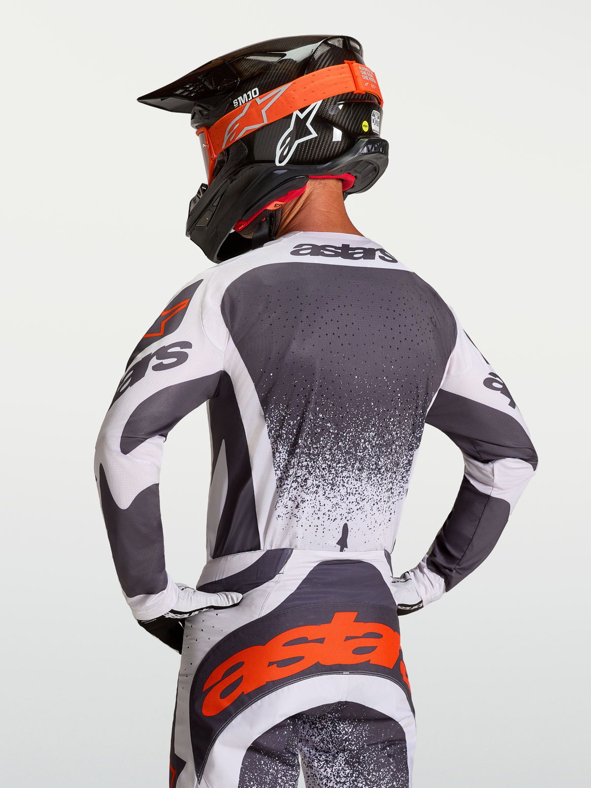 Alpinestars Techstar Swan Jersey, athletic race-fit motocross jersey in Dark Gray and White with Red highlights, shown on rider.
