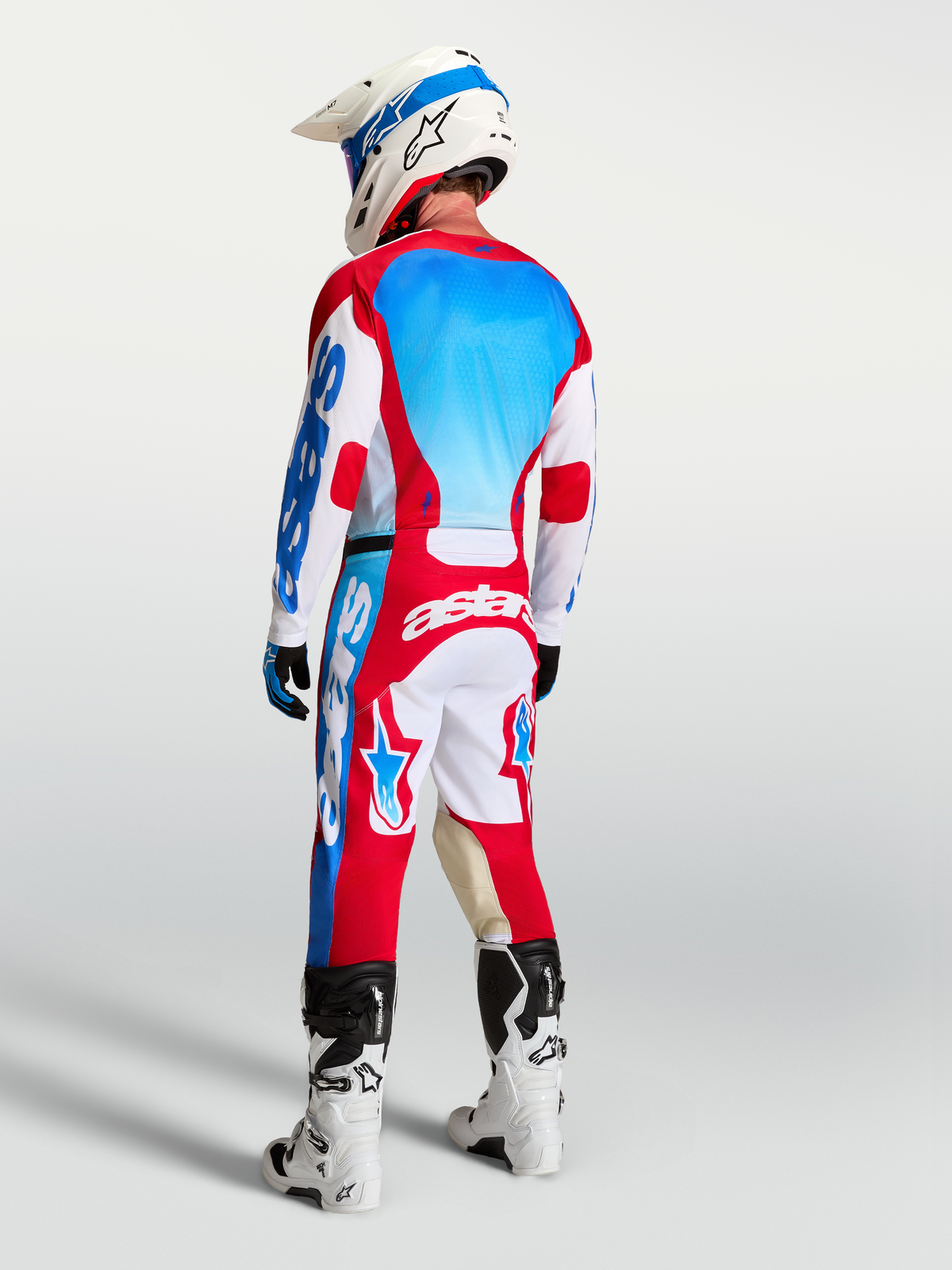 Alpinestars Racer Hunt Jersey and pants, men's red, white and blue motocross gear set with moisture-wicking polyfabric.