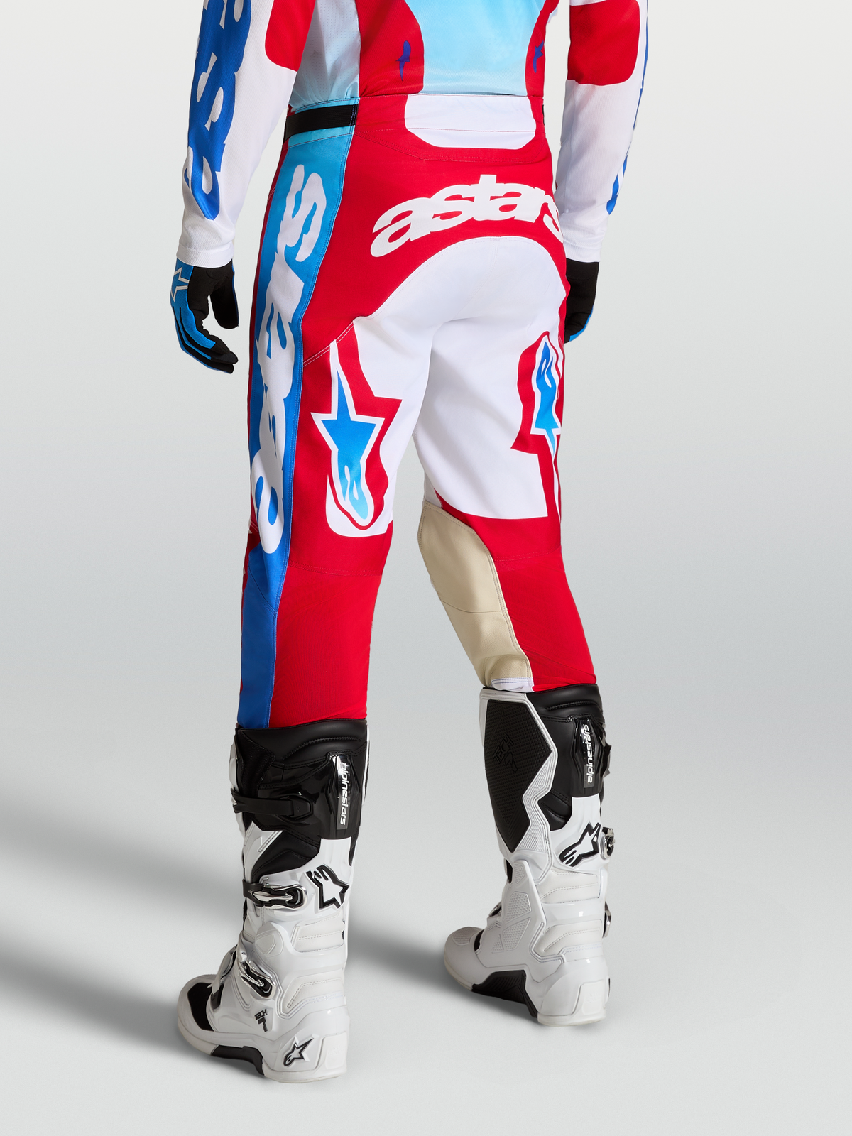 Racer Hunt Pants, Red and White motocross racing pants on-model with star graphics, goat leather knee panels, and ergonomic sport cut.