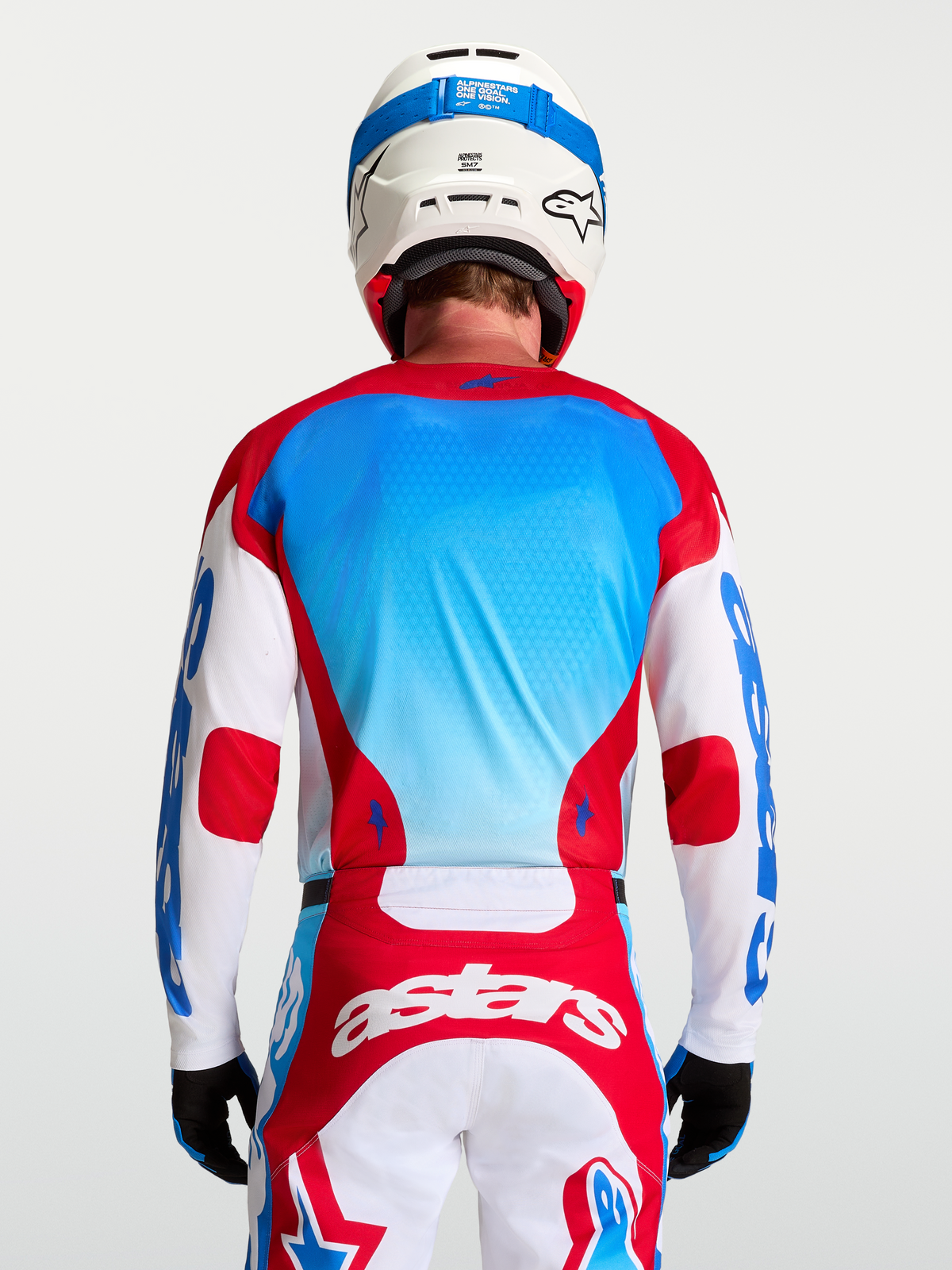 Alpinestars Racer Hunt Jersey, Men's Motocross Jersey, Red and UCLA Blue, breathable textile, rear view on model.