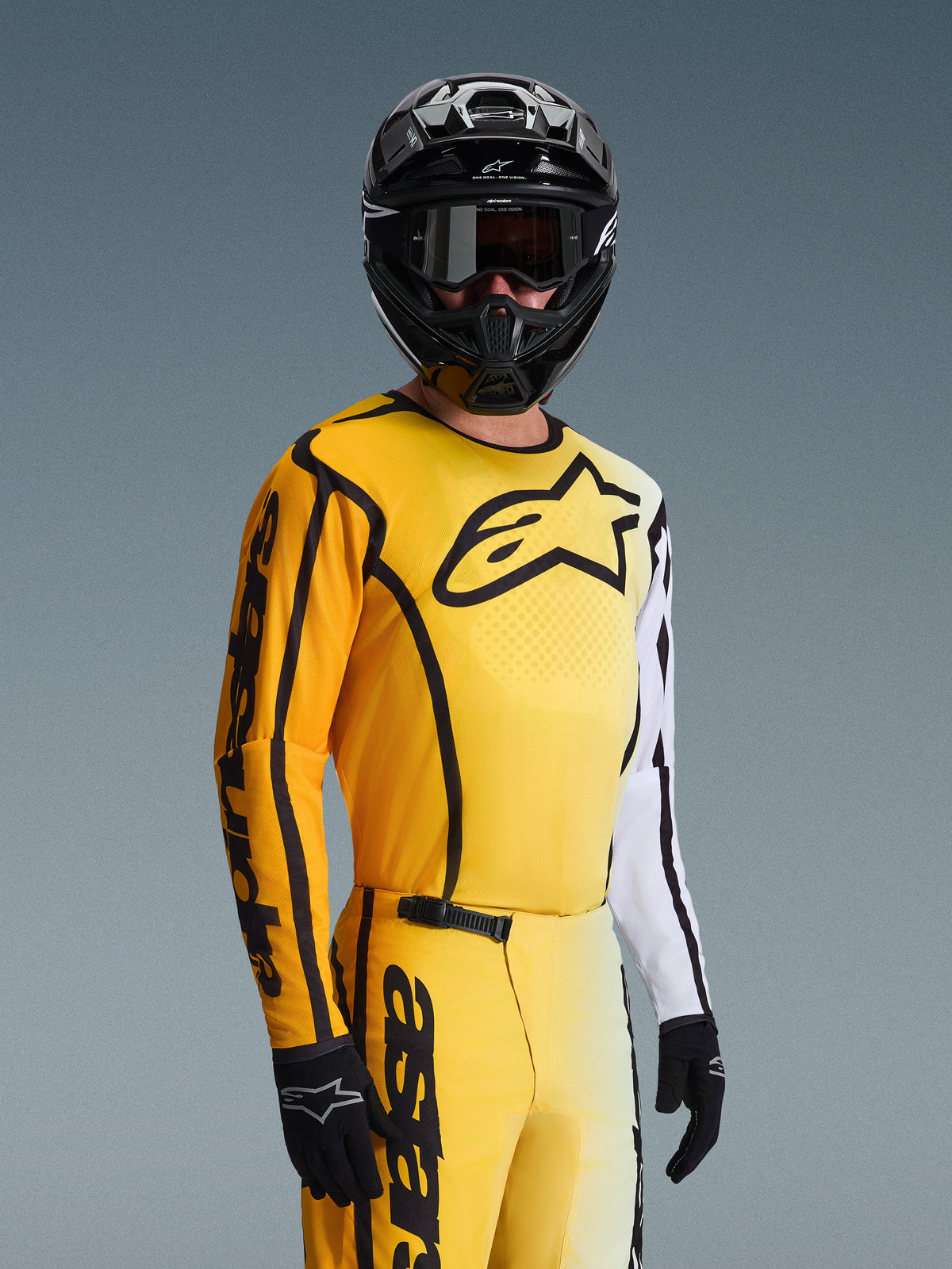 Alpinestars 2026 Fluid Apex Jersey, Motocross Jersey, Yellow and Black with white accents, worn by a rider with a black helmet and goggles, large black star logo on chest, coordinated off-road racing gearset