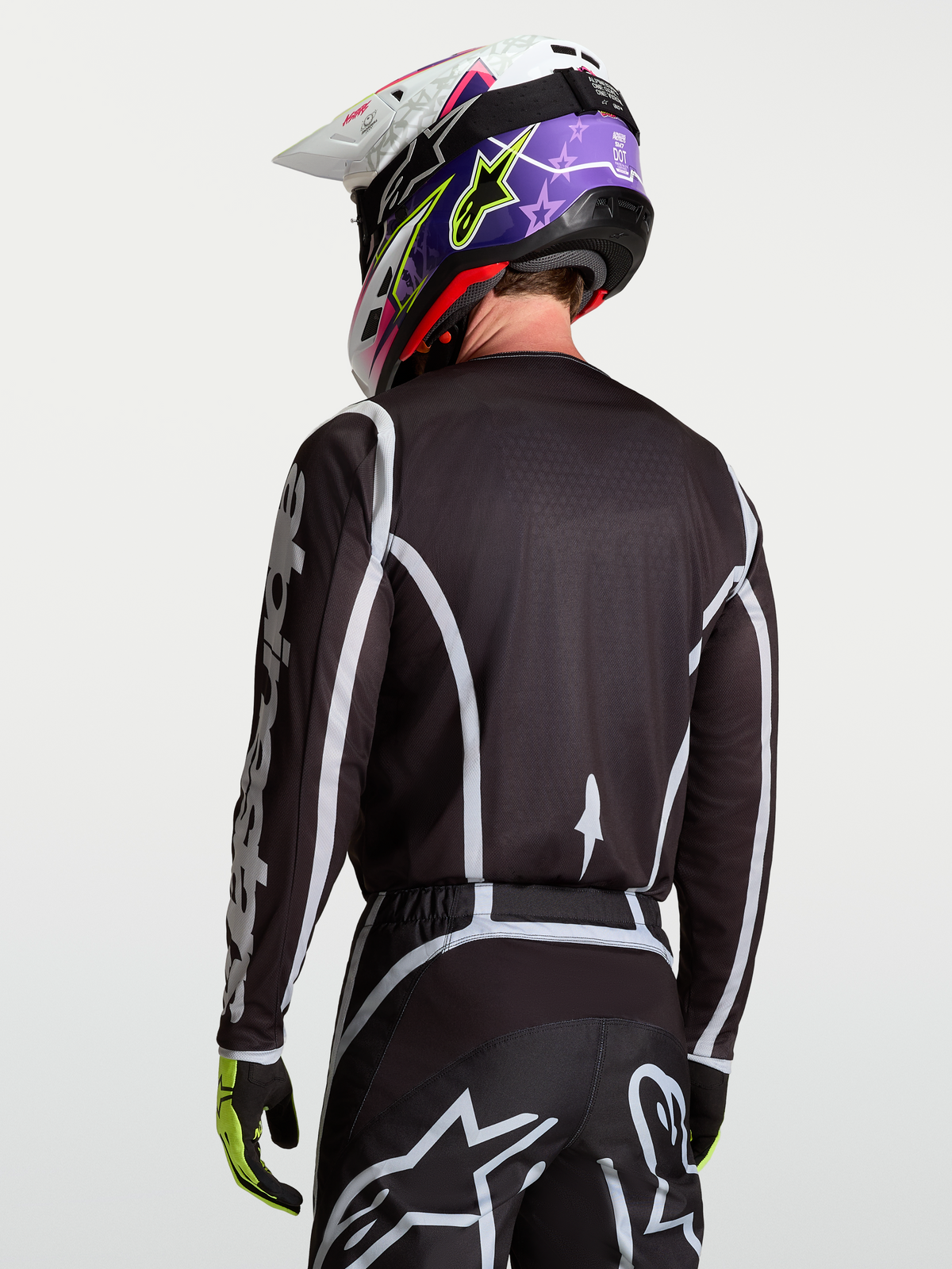 Alpinestars Fluid Apex V2 Trikot, Motocross-Oberteil für Herren, Rückansicht in Schwarz und Silber, feuchtigkeitsableitendes Polygewebe mit ergonomischem Schnitt.