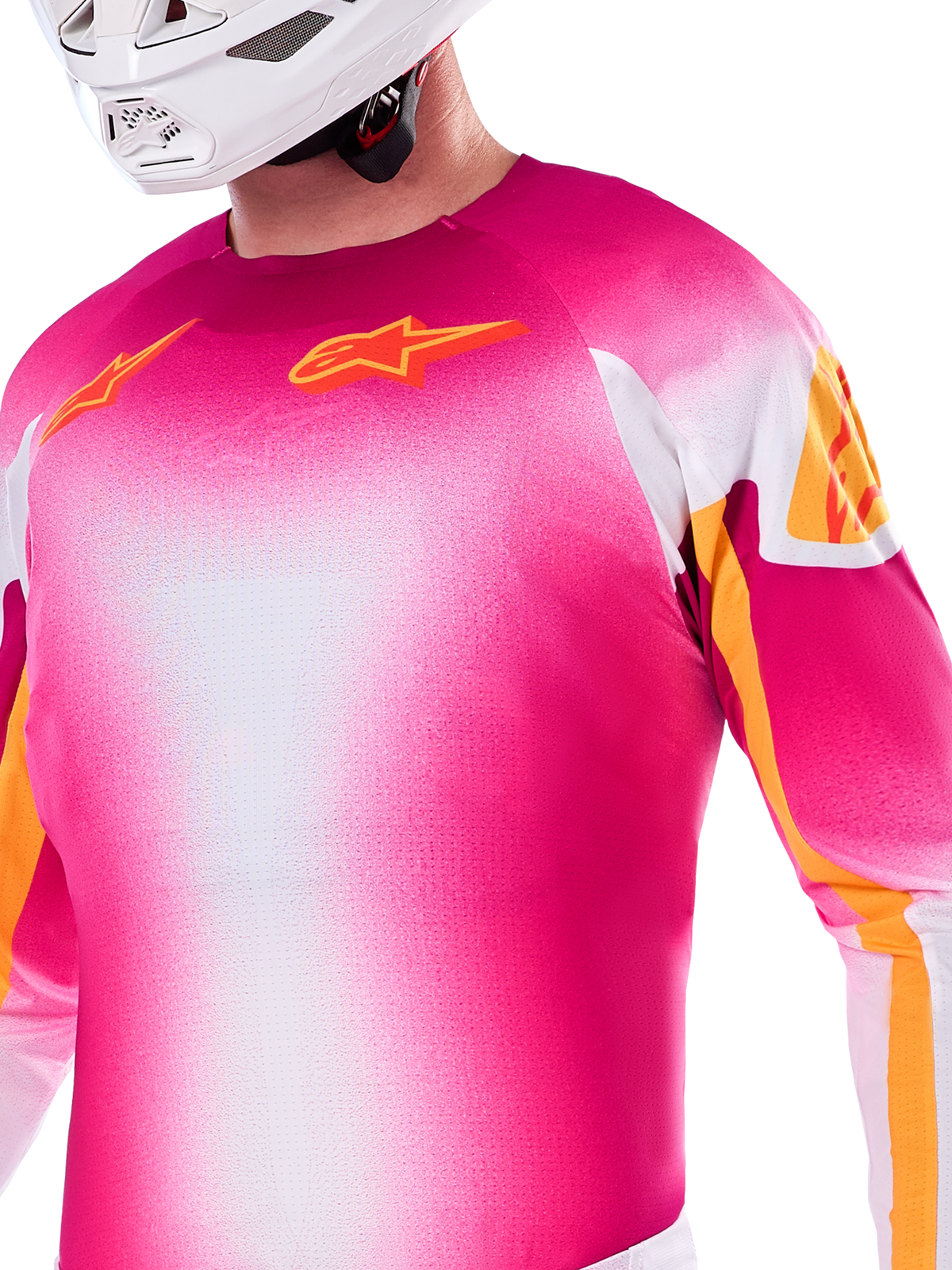 Alpinestars Limited Edition Supertech AFD MIG Jersey, Motocross Jersey in Pink Fluo and White gradient, featuring orange Astars logos and sleeve accents, worn by a rider with a white helmet, athletic racing fit.