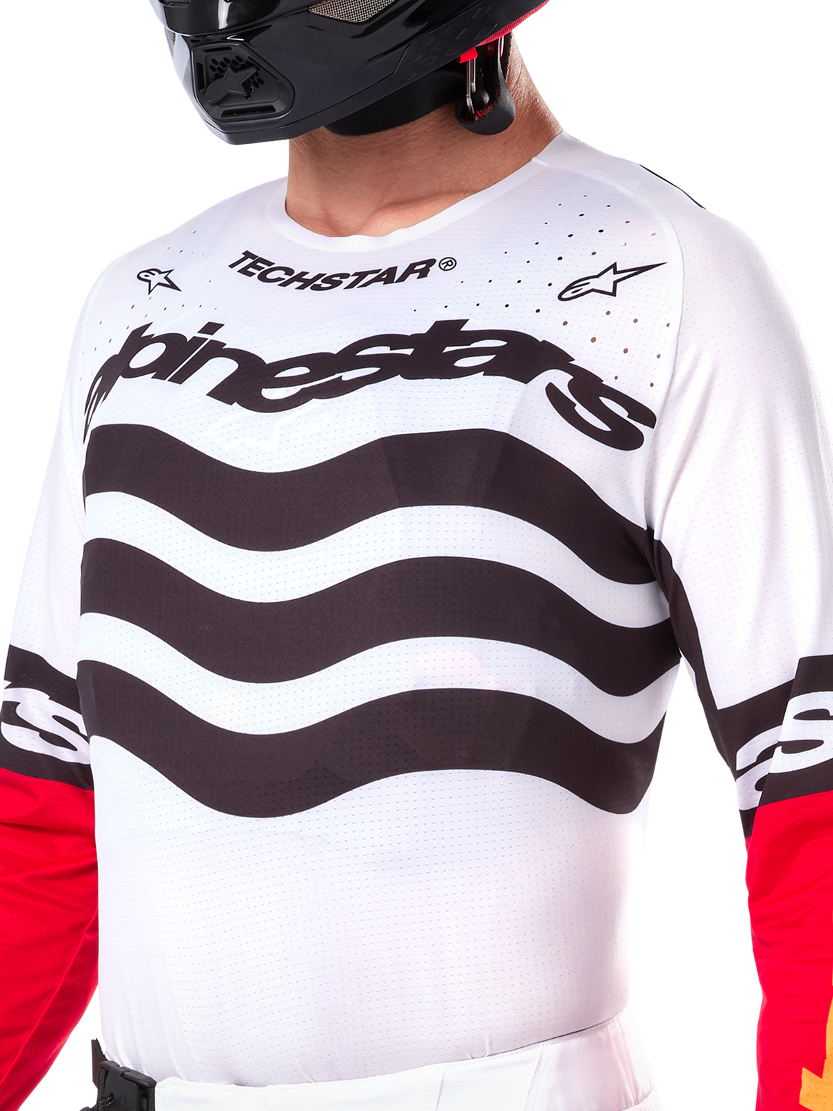 Alpinestars Limited Edition Techstar Deep Jersey, white motocross jersey with wavy black horizontal stripes and red sleeves, featuring Alpinestars and Techstar branding, small laser-cut perforations on the upper chest for ventilation, athletic off-road gear